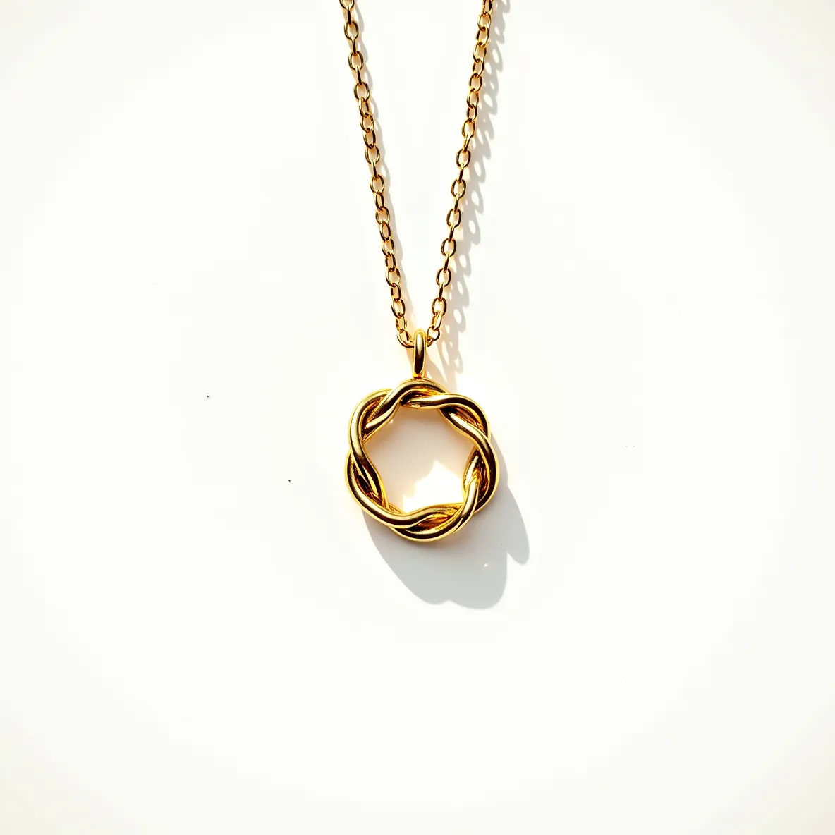 This knot necklace features a delicate chain and a pendant crafted in a metallic material with a polished gold finish. The pendant is intricately designed in a twisted rope style, forming an elegant knot shape that adds a touch of sophistication and timelessness to the piece. It is attached to the chain via a simple loop mechanism, ensuring that it hangs gracefully when worn. The chain itself consists of interlinked oval links, providing both durability and a classic aesthetic. The necklace likely fastens with a standard clasp, though the exact type is not visible. Overall, this piece combines simplicity and elegance, making it versatile for various occasions.