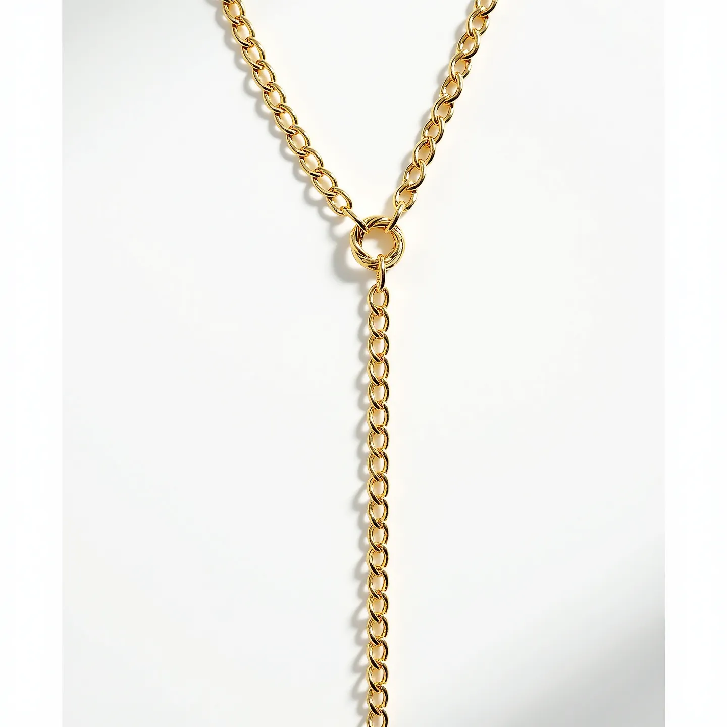 This lariat necklace is crafted from a polished gold-toned metal, featuring a chain composed of uniform oval links that provide a smooth, elegant drape. At the center, a circular loop interlocks the chain, creating the distinctive lariat design without the use of a traditional clasp. The absence of gemstones keeps the focus on the sleek, metallic texture and the versatile loop mechanism, which allows for adjustable styling. This design emphasizes simplicity and sophistication, making it a versatile accessory for a variety of outfits.