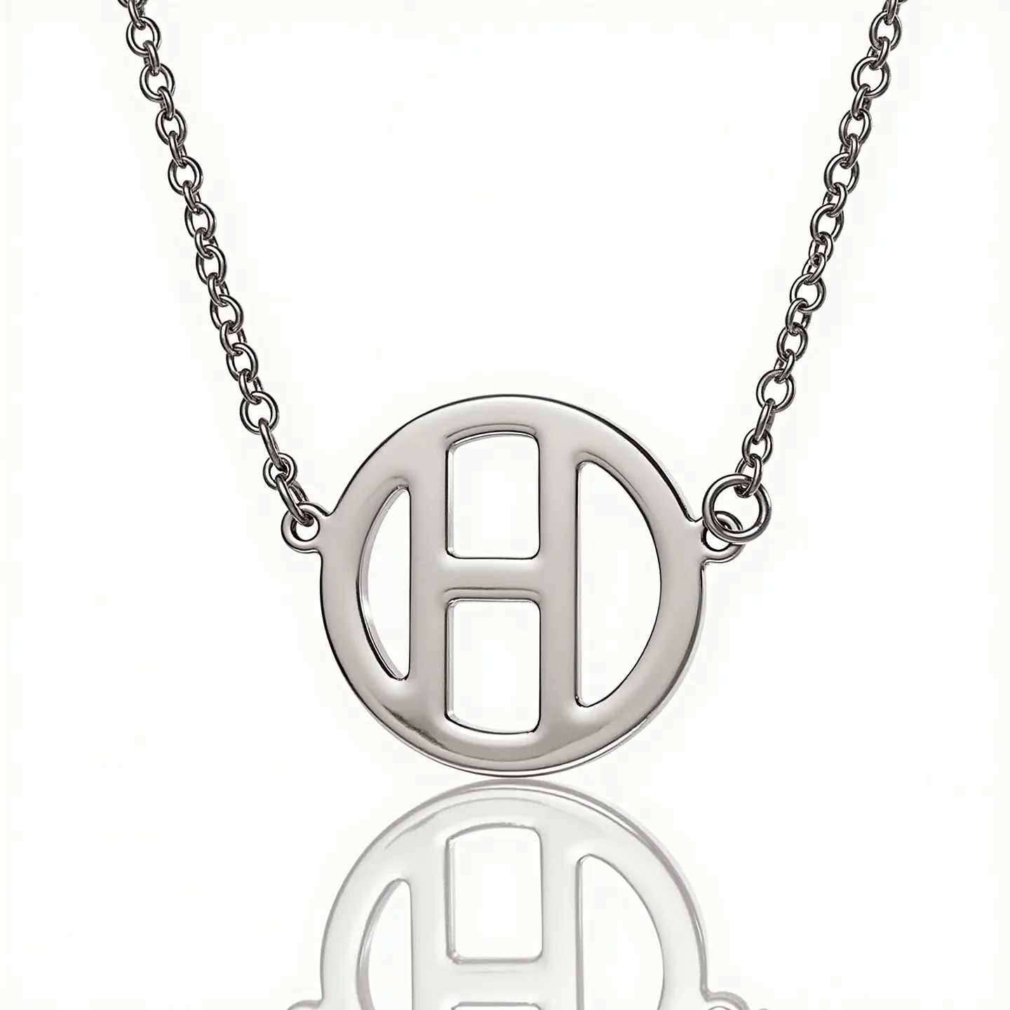 This letter necklace features a bold, polished metal charm shaped in the form of an "H" set within a circular outline, creating a sleek and modern design. The material of the pendant and chain appears to be a shiny silver-tone metal, lending the piece an elegant and versatile look. The necklace includes a delicate, matching chain that connects seamlessly to the pendant, suggesting a sturdy and well-crafted attachment. The overall design is minimalist yet striking, making it suitable for both daily wear and special occasions.