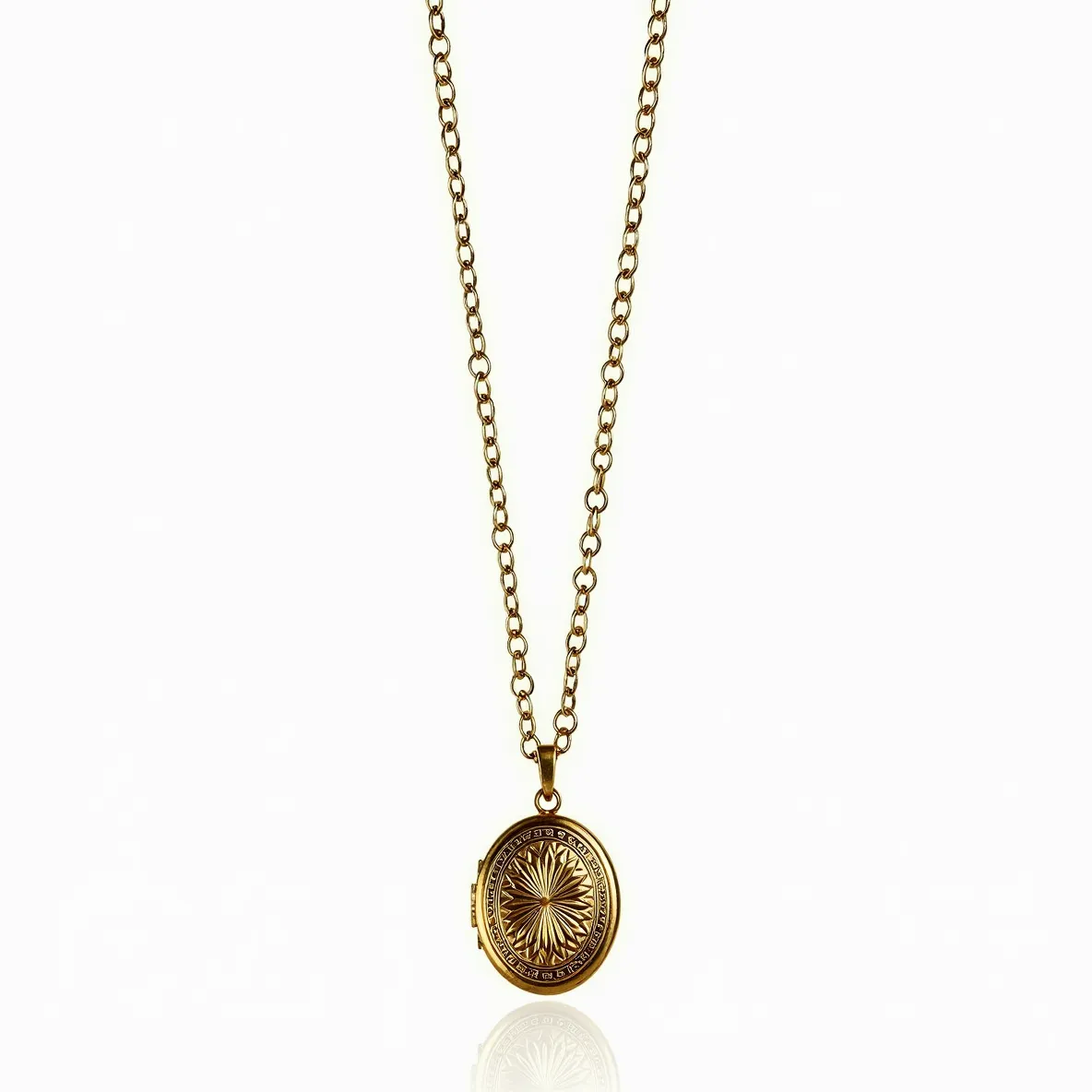 This locket necklace features a gold-toned metal chain and an oval-shaped locket with an intricate starburst design on the front. The chain is composed of medium-sized links, providing both durability and an elegant appearance. The locket itself appears to be crafted from a complementary gold-toned metal, enhancing its cohesive look with the chain. The locket design is further accentuated by engraved details surrounding the starburst pattern, giving it a vintage-inspired aesthetic. The necklace is completed with a simple, functional clasp to ensure secure fastening.