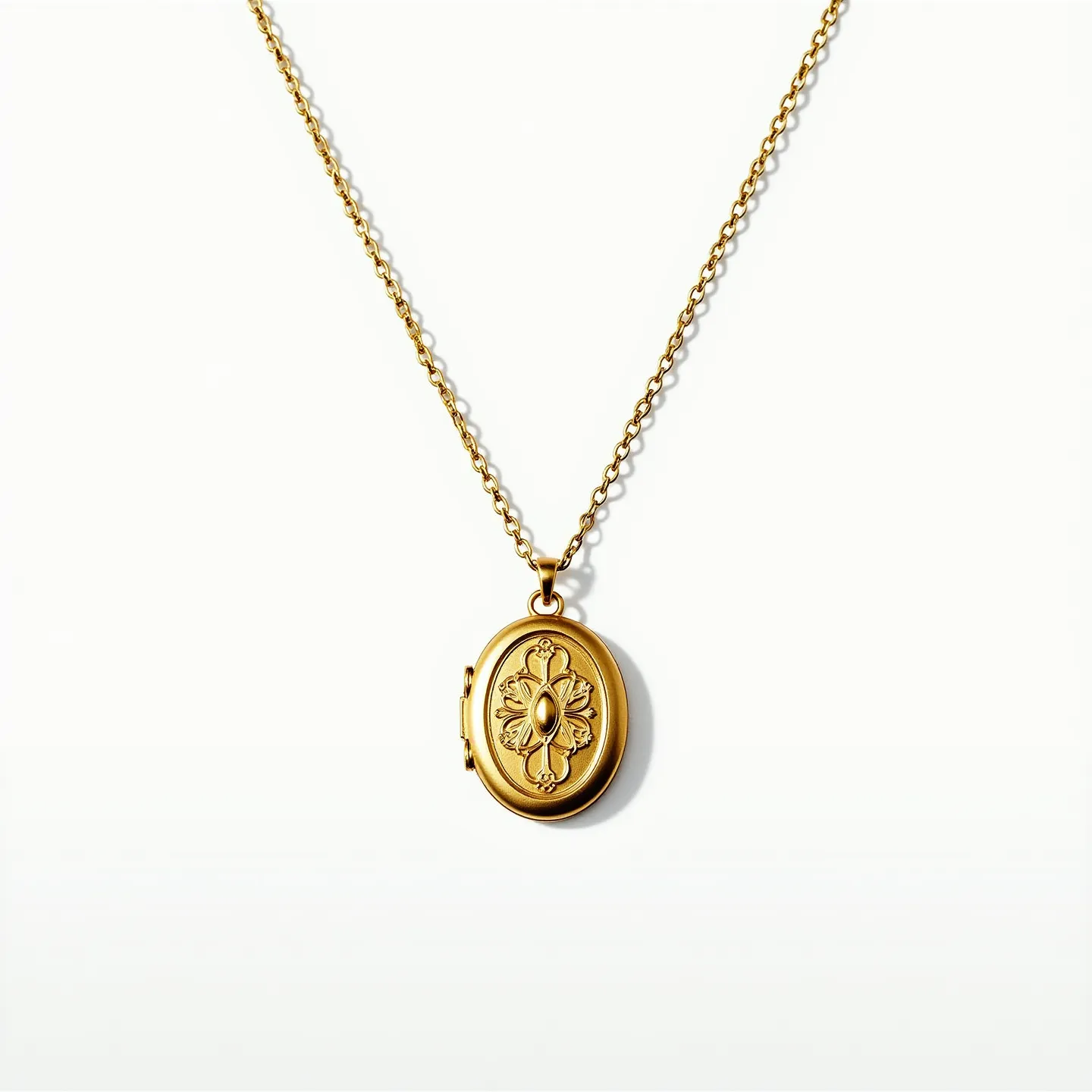 This locket necklace features an intricately designed gold oval locket suspended from a delicate gold chain. The locket's face showcases an elegant, engraved floral motif, highlighting a central oval shape that could potentially hold a small gem or stone, although it appears to be crafted from metal as well. The chain is composed of small, uniform links, ensuring both durability and a classic, refined appearance. The locket is attached to the chain via a small, sturdy bail that complements the overall design. A traditional spring ring clasp secures the necklace, providing an easy and reliable closure.