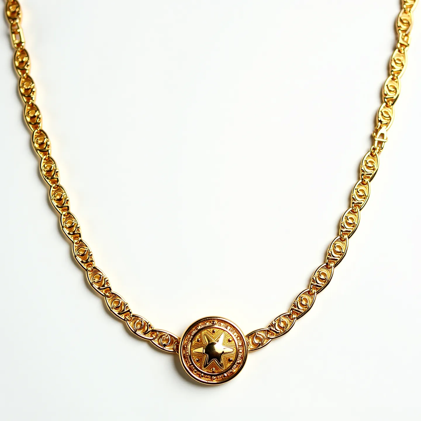 This long gold necklace is composed of intricately designed links, each crafted to form a continuous flowing pattern. It features a central decorative medallion, where a prominent star motif is set in relief. The medallion is surrounded by a circular border, adding a sense of depth and symmetry to the design. No gems or stones are present within the medallion, focusing attention on the gold craftsmanship. The clasp or attachment details are not explicitly visible, yet the necklace's seamless appearance suggests a sophisticated closure mechanism, maintaining the overall elegance and fluidity of the piece.