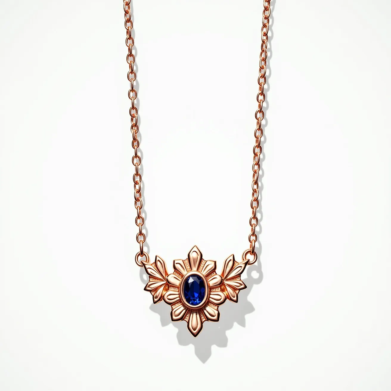 This long gold necklace features an intricate pendant design, highlighted by a central oval-cut blue sapphire. The gem is securely set in a bezel setting, which enhances its brilliance against the warm tones of the gold. The pendant showcases an elegant floral motif, with delicate petal-like extensions around the sapphire, emphasizing its centerpiece allure. The necklace is composed of a gold chain with interlocking links, providing both durability and an elegant drape. The piece is completed with a secure clasp that ensures practicality and ease of wear, making it a sophisticated and timeless accessory.