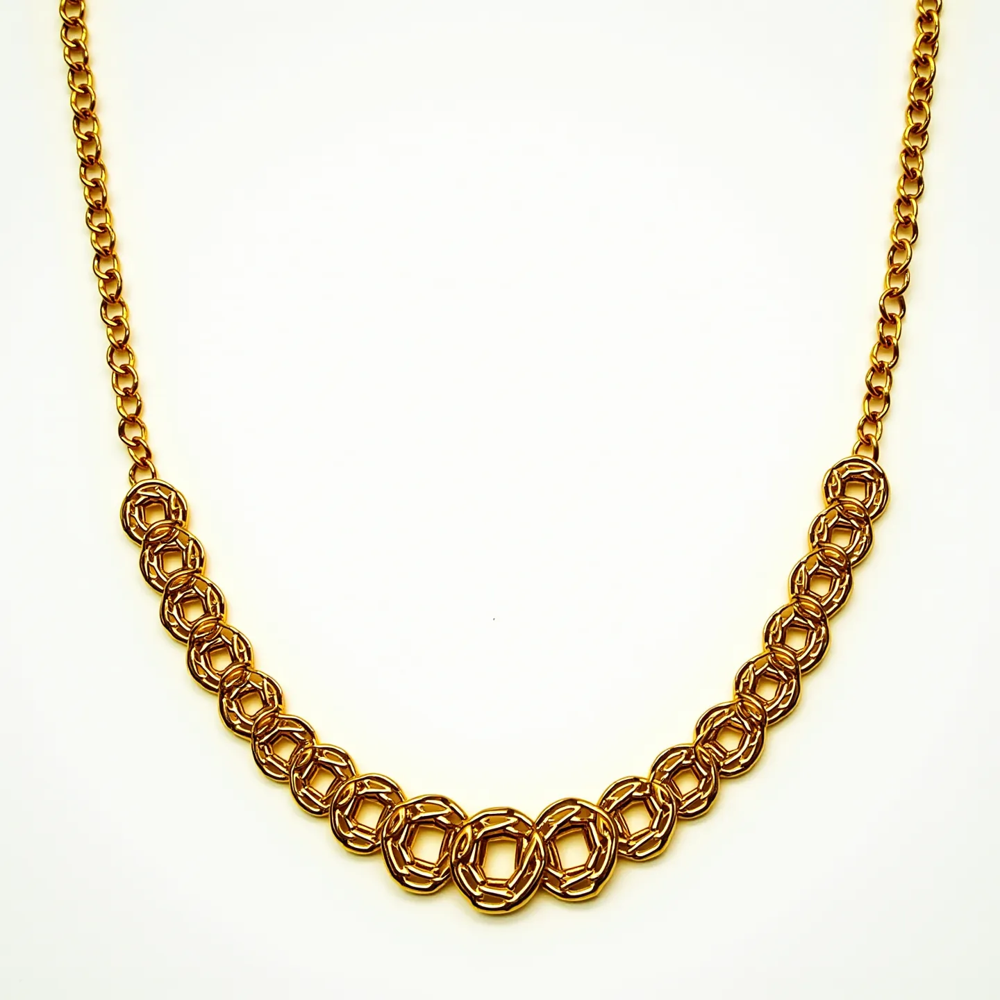 This long gold necklace features a series of interlocking, intricately designed chain links that form a captivating pattern. The links are crafted to give a textured, geometric look, enhancing the necklace's visual appeal. The rich gold color adds to its luxurious feel, and the design appears consistent along its length. The necklace likely has a clasp that allows for secure fastening, though the image may not show specifics. Its elegant craftsmanship suggests it’s suitable for both formal and casual occasions.