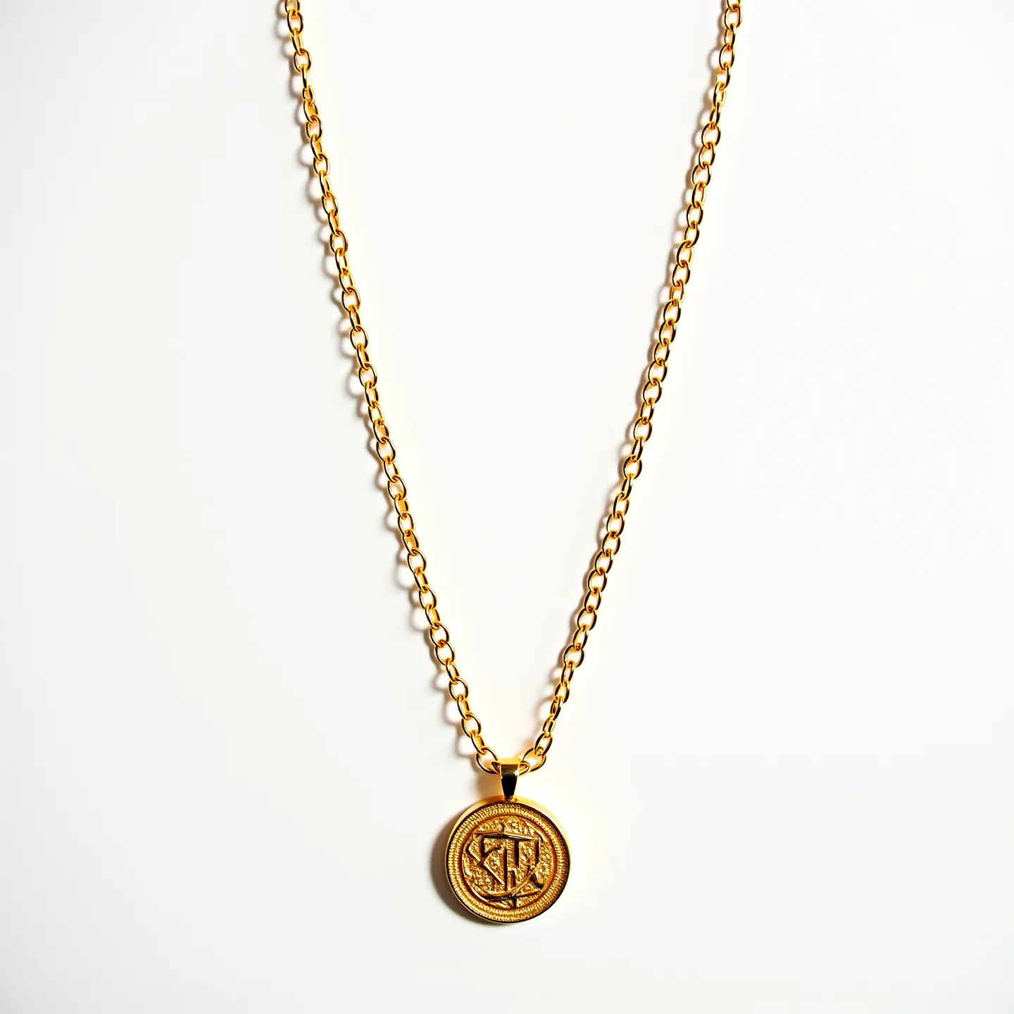 This long gold necklace features a sturdy chain composed of interlocking links, giving it a classic and timeless appearance. It is crafted from high-quality gold, which provides a rich and warm luster. The necklace is adorned with a round gold pendant that appears to be engraved with an intricate design, contributing to its elegant aesthetic. The pendant is smoothly integrated into the chain, providing a seamless and fluid look. The necklace is complete with a simple yet secure clasp, ensuring it stays fastened when worn.