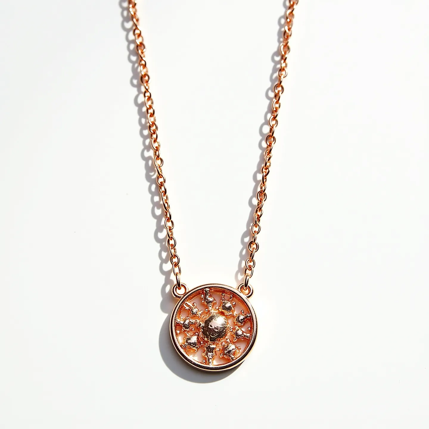 This long gold necklace features a delicate chain with interlocking links, crafted in a warm gold tone. At its center hangs an ornate circular pendant, which is highlighted by a sunburst design. The pendant contains small sparkling gems set into the sun's rays, adding an element of elegance and shine. The gems are round in shape, enhancing the piece's radiant appearance. The necklace is completed with a simple clasp that ensures a secure and comfortable fit, enhancing its luxurious and refined aesthetic.