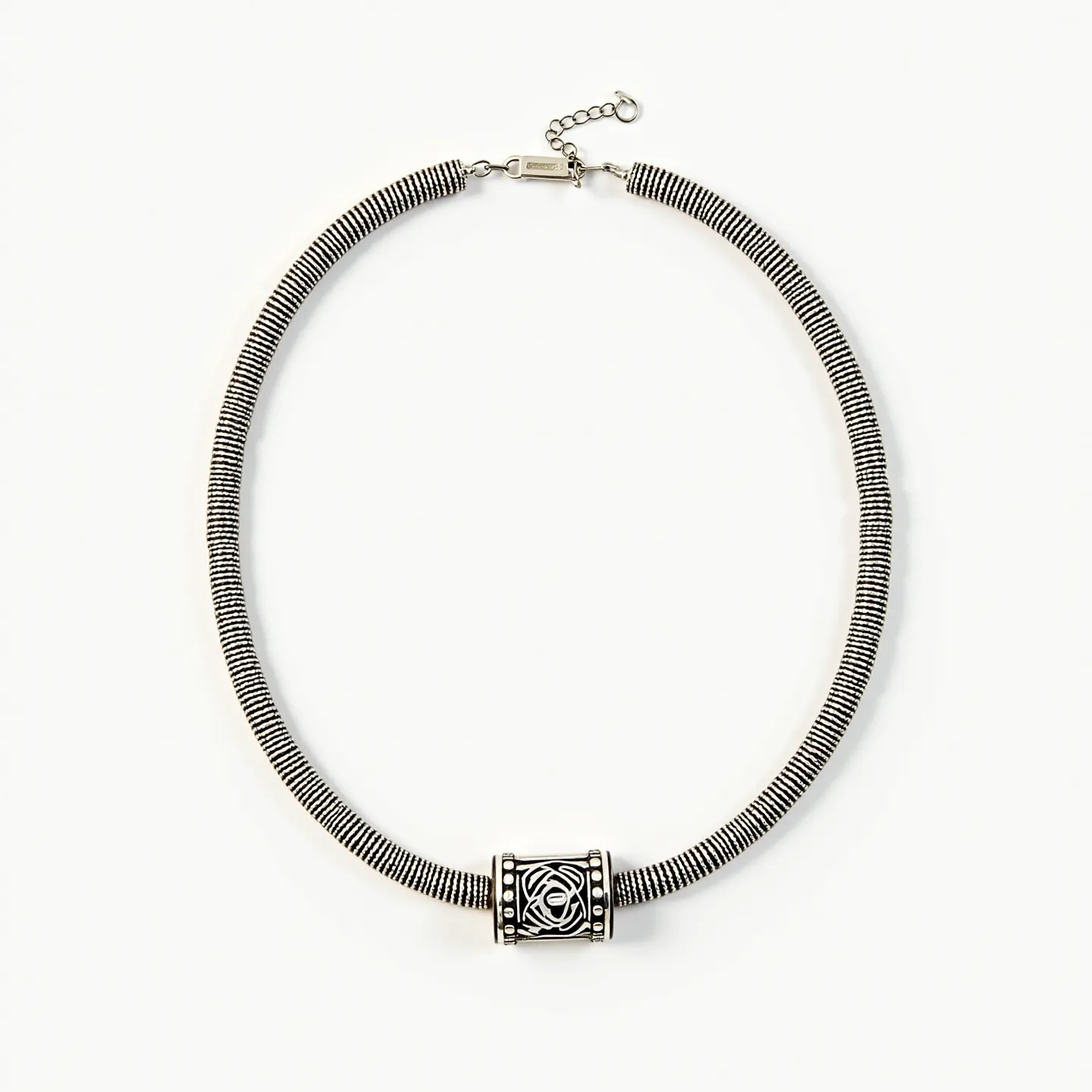 This men's beaded necklace features a distinctive barrel-shaped central bead with an intricate engraved pattern, likely crafted from metal. The surrounding beads have a coiled or spiraled design that suggests they are made from metal wire, possibly silver or stainless steel, giving the piece a sleek, modern aesthetic. The necklace is equipped with a lobster clasp for secure fastening, which is connected to an adjustable chain that allows for length customization. The overall design is both stylish and versatile, suitable for various occasions.