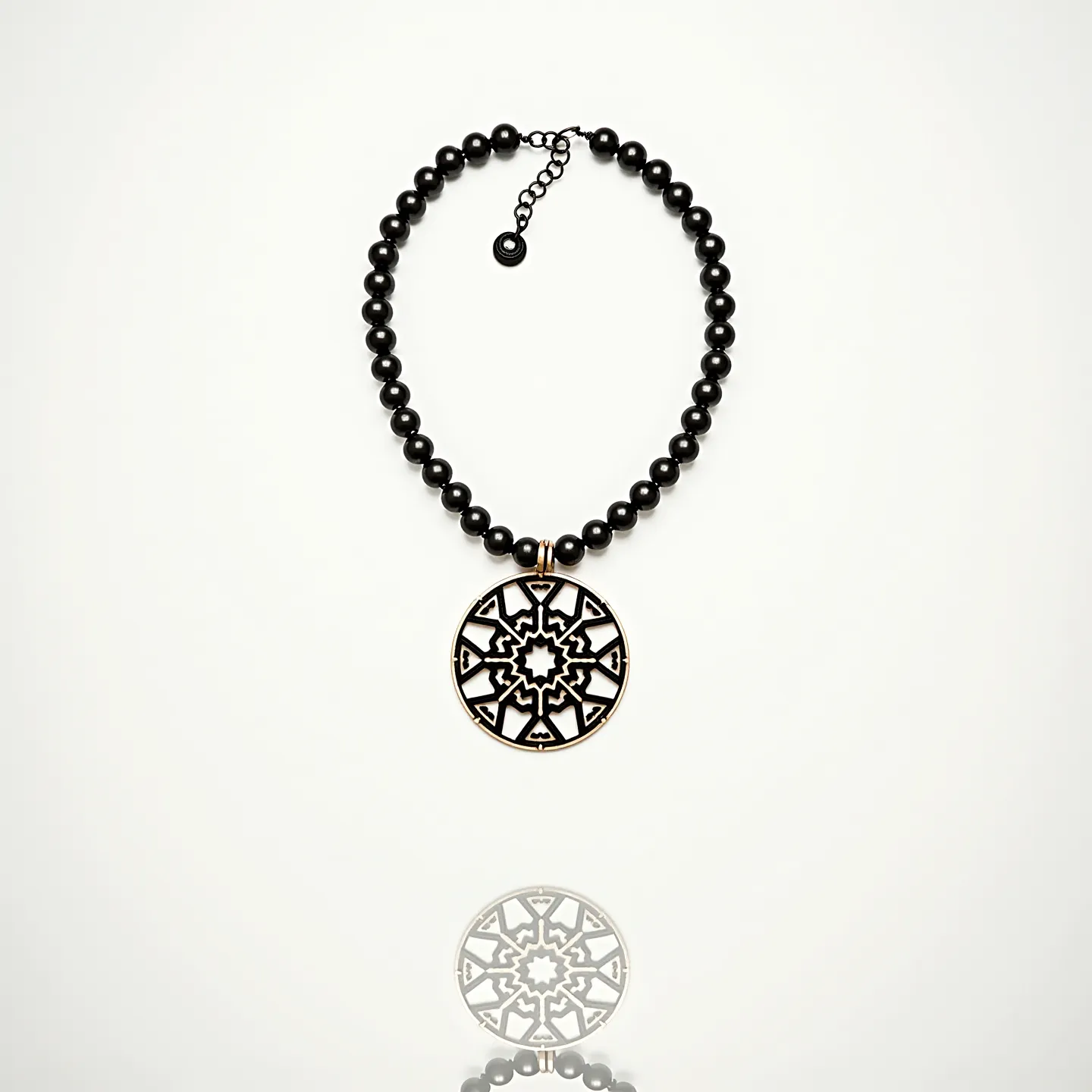 This men's beaded necklace features sleek black beads likely made from onyx or a similar material, strung together to form a classic, bold look. At the center of the necklace is an intricately designed circular pendant with an artistic, geometric cutout pattern, adding a distinctive focal point to the piece. The beads are smoothly rounded, providing uniformity and coherence throughout the necklace. It is equipped with an adjustable chain clasp, allowing for customizable fit and ease of wear. The combination of dark beads and the detailed pendant creates an elegant and striking accessory suitable for various occasions.