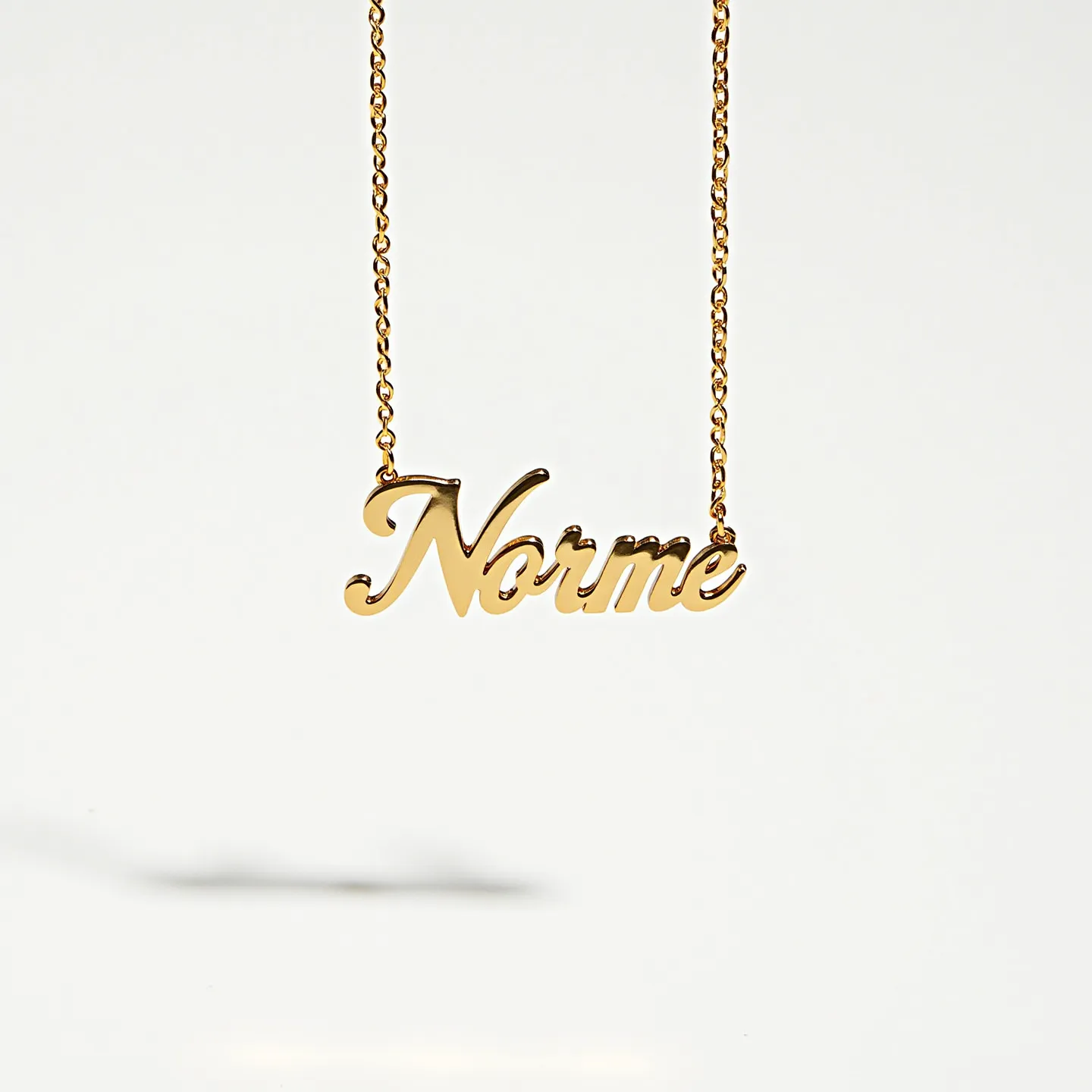 This name chain necklace features a polished gold material that enhances its elegant and stylish appearance. The name "Norme" is crafted in a cursive script, giving it a personal and sophisticated touch. The chain is likely made of a delicate link style, which complements the smooth surface and shine of the nameplate. There are no visible gemstones or additional decorative elements on the necklace, making it a straightforward yet charming piece. The design suggests it may use a type of clasp commonly found in fine jewelry, maintaining its streamlined and classic look.