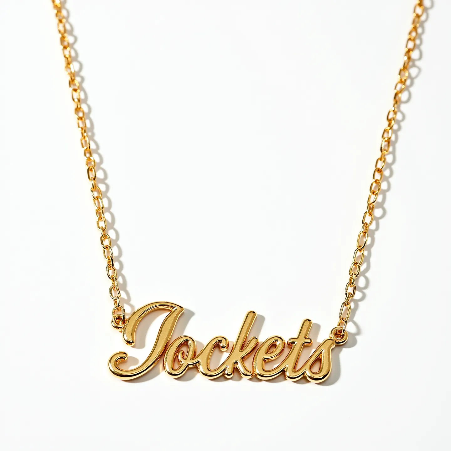 This name chain necklace features an elegant design with a bright gold-tone finish, showcasing the word "Jackets" in a script style. The chain is composed of oval links that provide a classic and versatile look. The attachment is subtle, likely utilizing a spring ring clasp for secure fastening. The overall design is sleek and polished, drawing attention with its shiny surface. There are no additional gems or stones incorporated into the necklace, allowing the name pendant to be the focal point of the piece.