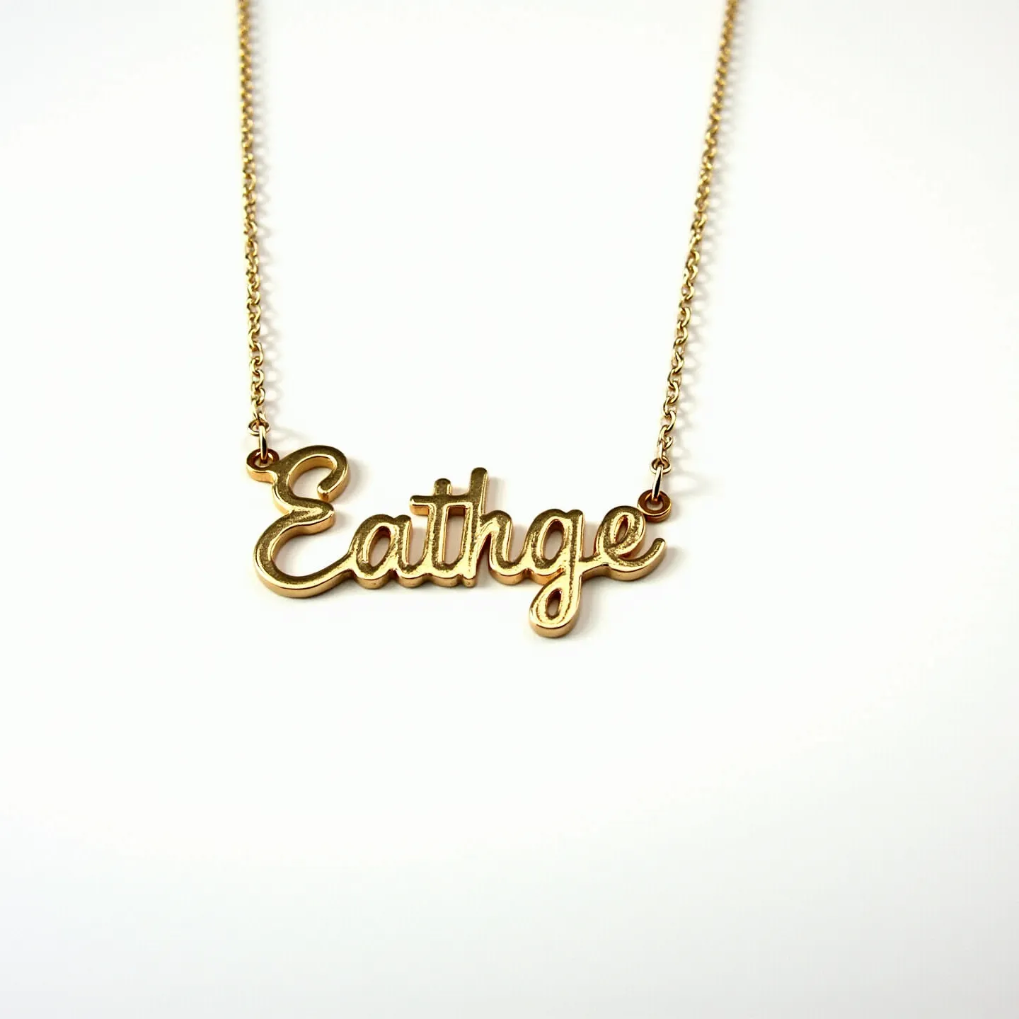 This name chain necklace features a delicate gold-tone chain and a custom nameplate centerpiece meticulously crafted in a cursive font. The chain is finely linked, offering both strength and elegance, while the nameplate is polished to a smooth finish, enhancing its luminous appearance. The necklace employs a standard jump ring attachment at each end of the nameplate, seamlessly connecting it to the chain. The closure mechanism is not depicted, but it typically involves a spring ring or lobster clasp for secure and easy fastening. The simplistic and elegant design of this necklace makes it a versatile accessory suitable for various occasions.