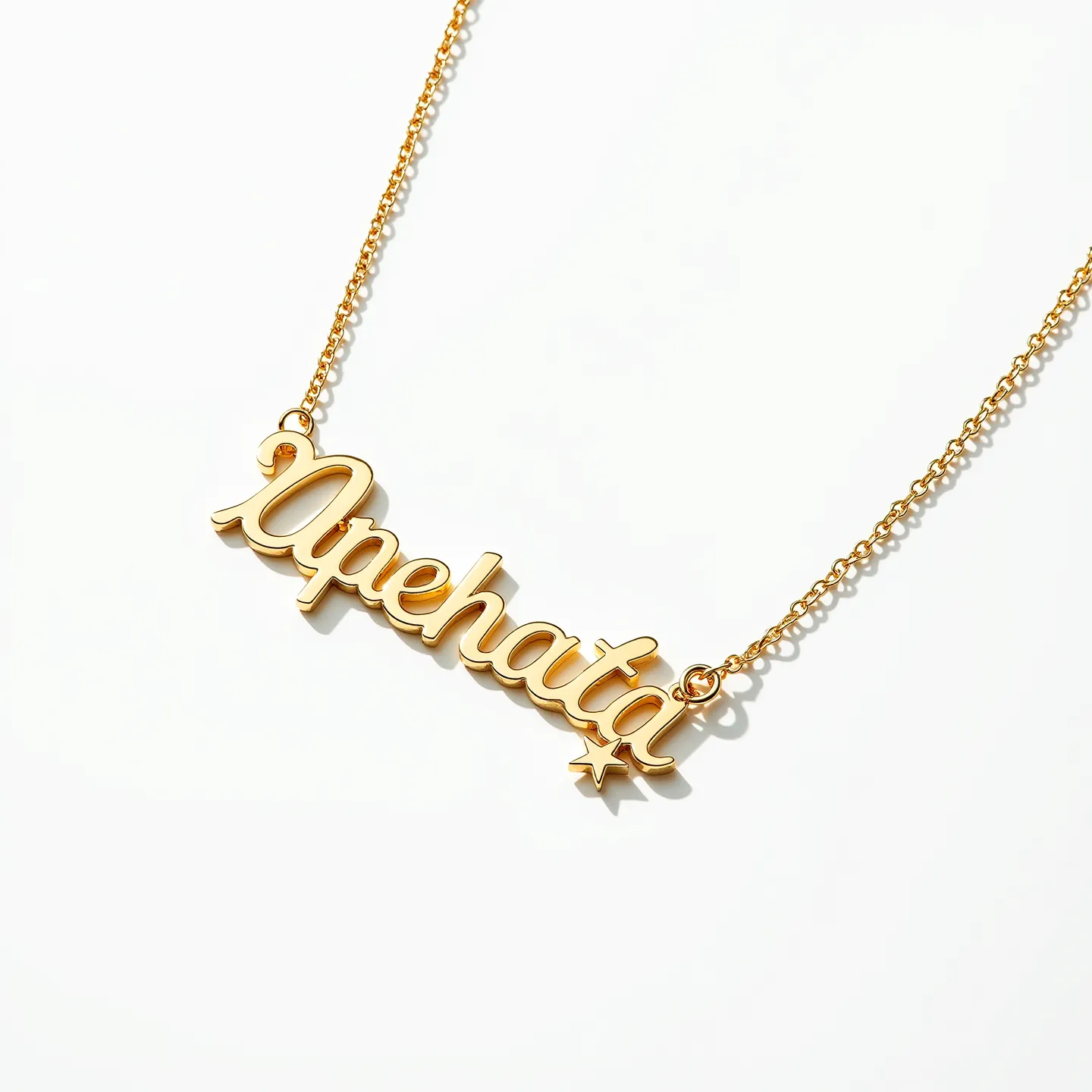 This name necklace features a gold tone with a dedicated chain attached at both ends of the pendant. The lettering appears to be crafted from a metal with a polished finish, showcasing a delicate and smooth script style. There is a small star detail at the end of the name, adding an elegant touch. The necklace is connected with a fine chain that complements the overall design. The clasp is not visible, but the attachment appears secure, designed to hold the pendant evenly when worn.