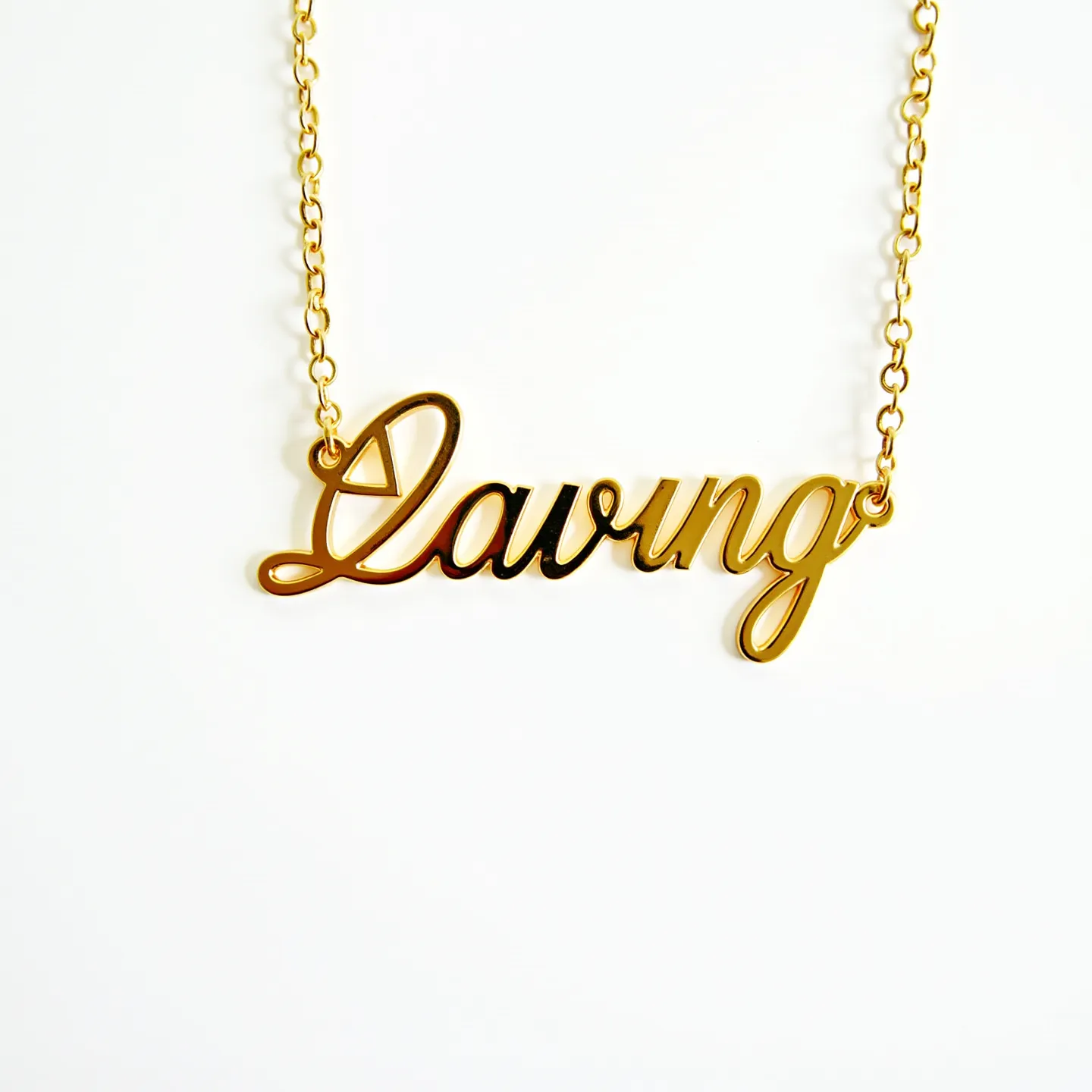 This name necklace features a script-style design constructed from a polished gold material, exuding elegance and simplicity. The name is presented in a cursive font, adding a personalized touch to the piece. The necklace is suspended from a delicate, matching gold chain that is linked to each end of the nameplate. The chain consists of small, circular links that create a cohesive and seamless look. The absence of additional gems or stones maintains the necklace’s minimalist aesthetic, focusing attention on the crafted name. A standard clasp at the back ensures a secure fit when worn.