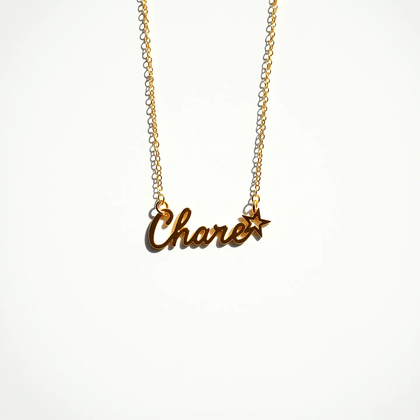 This name necklace features the name "Charee" crafted in a cursive style, made of a material with a gold finish, offering a classic and elegant appearance. Attached to the final letter is a small star, also in a gold tone, adding a playful and whimsical touch to the necklace. The chain consists of delicate links that complement the pendant's elegant design. The necklace appears to have a standard clasp attachment, ensuring it secures comfortably around the neck. The overall design is both personalized and stylish, making it a versatile accessory for various occasions.