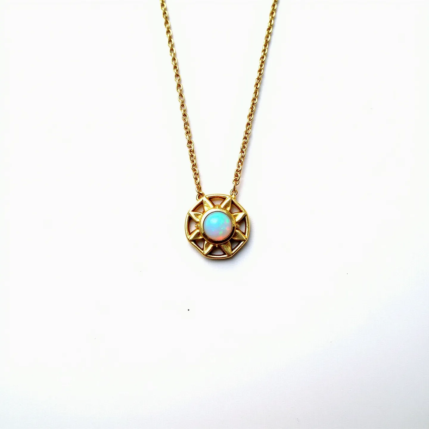 This opal necklace features a delicate gold chain that supports a circular pendant. The center of the pendant showcases a smoothly polished opal, known for its iridescent play of colors, primarily displaying hues of blue and white. Encircling the opal is an ornate design resembling a sunburst pattern, crafted from gold, which complements the central stone. The opal is securely set in a bezel setting, providing both protection and a stylish look. The necklace is likely fastened with a standard gold clasp, ensuring it hangs elegantly around the neck.