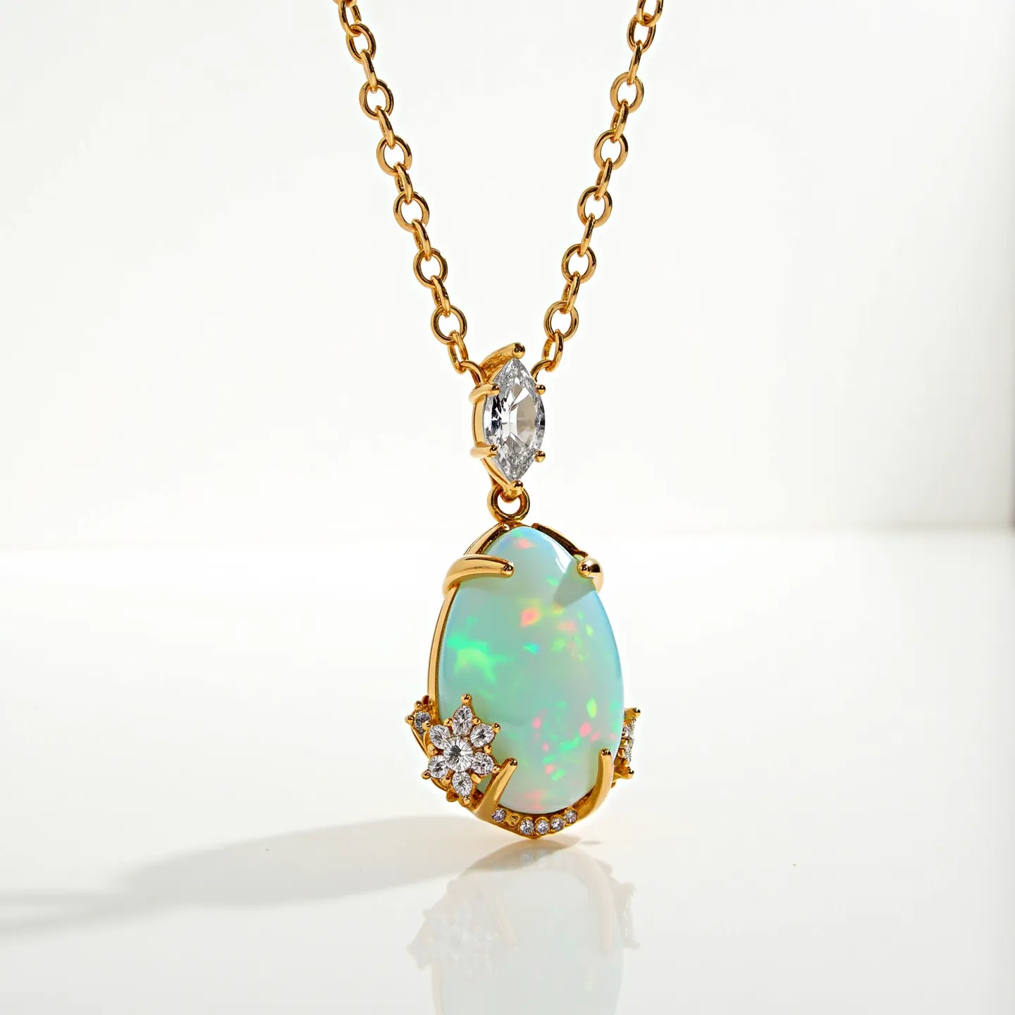 This opal necklace features a stunning opal gemstone with a vibrant play of color, set in a prong setting that holds the stone securely in a gold framework. The opal is complemented by a marquise-cut clear stone positioned above it, adding an elegant touch. Surrounding the opal are additional sparkling embellishments, possibly diamonds or cubic zirconia, arranged in a floral motif that enhances the necklace's luxurious appearance. The gold chain, composed of interlinked oval links, provides a classic and timeless look. The necklace likely has a secure clasp to ensure it stays in place when worn.