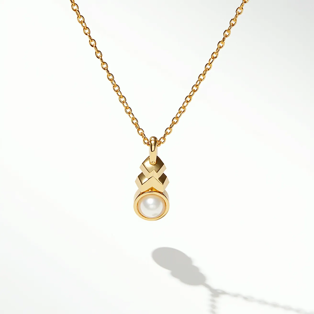 This pearl necklace features a delicate chain crafted from polished gold, which elegantly supports a distinctive pendant design. The centerpiece of the pendant is a single lustrous pearl, smoothly encased in a gold bezel setting that enhances its natural sheen. Above the pearl, the pendant incorporates a geometric gold design, adding a modern touch to its classic allure. The chain appears to use simple yet secure links, providing both flexibility and strength, ensuring the pearl pendant is the focal point of the piece. Overall, the combination of gold and pearl creates a sophisticated and timeless aesthetic.