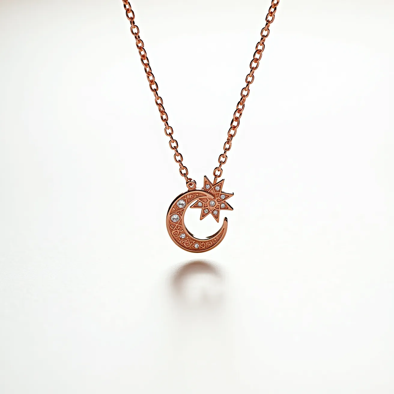 This pendant necklace features a delicate chain crafted from a warm, rose-gold-toned metal, complementing the intricately designed crescent moon and star pendant. The pendant is adorned with small, sparkling gems set strategically along the crescent's curve and within the star, suggesting they might be diamonds or cubic zirconia. The stones appear to be round cut, securely held in place with a bezel or prong setting that enhances their brilliance. The necklace is likely to have a simple lobster clasp or spring ring for secure closure. Overall, its celestial theme is elegantly highlighted by the harmonious combination of metal and stones.