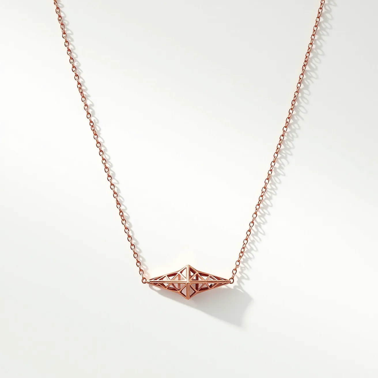 This pendant necklace features a geometric design crafted in rose gold-toned metal. The pendant itself has a unique, angular structure with a triangular, open framework, emphasizing modern architectural elements. It hangs from a delicate rose gold-toned chain, which complements the pendant’s bold design. The necklace is likely secured with a standard, matching clasp that ensures easy wearability. The overall design is minimalist yet striking with its contemporary elegance.