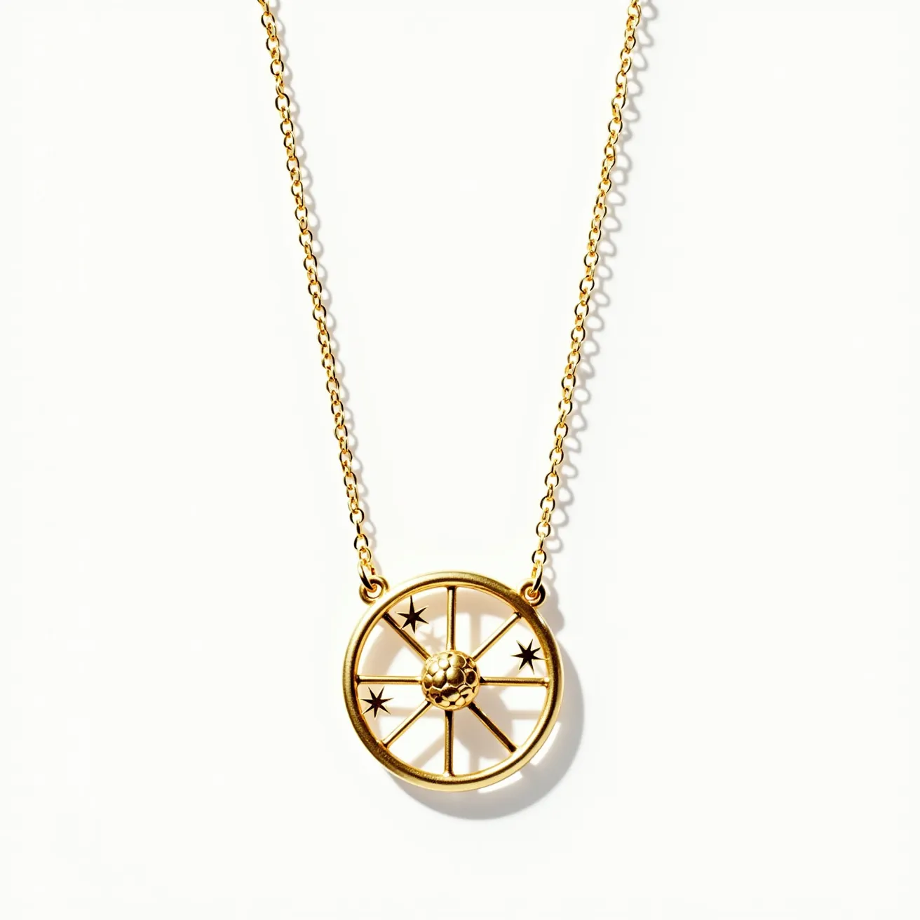 This pendant necklace features a circular gold pendant designed to resemble a wheel with spokes. The pendant includes intricate star motifs interspersed among the spokes, giving an artistic celestial feel. At the center of the pendant is a textured spherical element, adding depth to the design. The necklace chain is also crafted from gold and appears to be a delicate link chain. The attachment mechanism involves small loops on either side of the pendant, seamlessly integrating it into the chain. The overall design reflects elegance and a touch of whimsy, making it suitable for both casual and formal occasions.