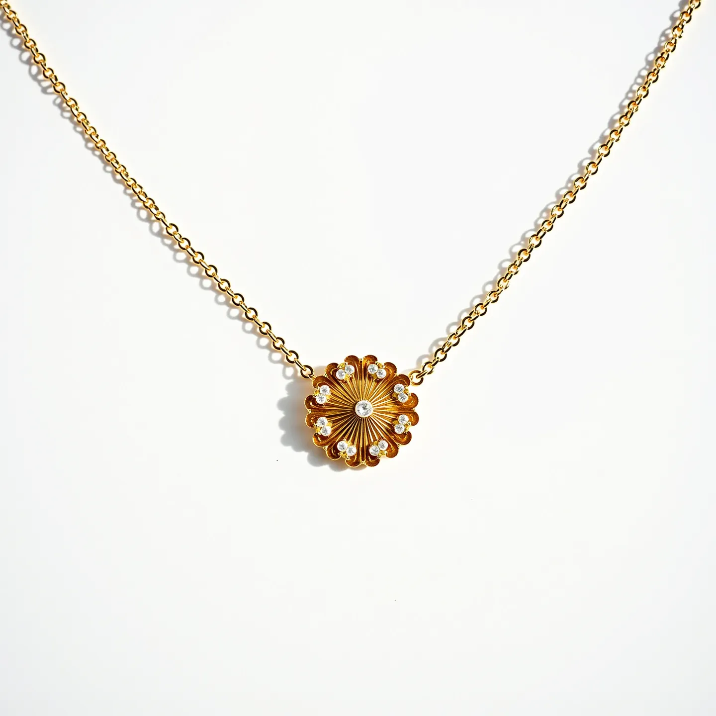 This pendant necklace features a delicate gold chain that complements the intricately designed pendant, which resembles a floral motif. The centerpiece of the pendant is adorned with a circular arrangement of sparkling, round-cut clear stones, likely diamonds or cubic zirconia, each precisely embedded in a prong setting to enhance their brilliance. The stones are arranged in a radiating pattern from the center, ensuring a harmonious balance and a captivating sparkle. The pendant is intricately designed to emphasize both elegance and femininity, making it a striking piece suitable for various occasions. The necklace appears to have a simple yet secure clasp, ensuring ease of wear and comfort.