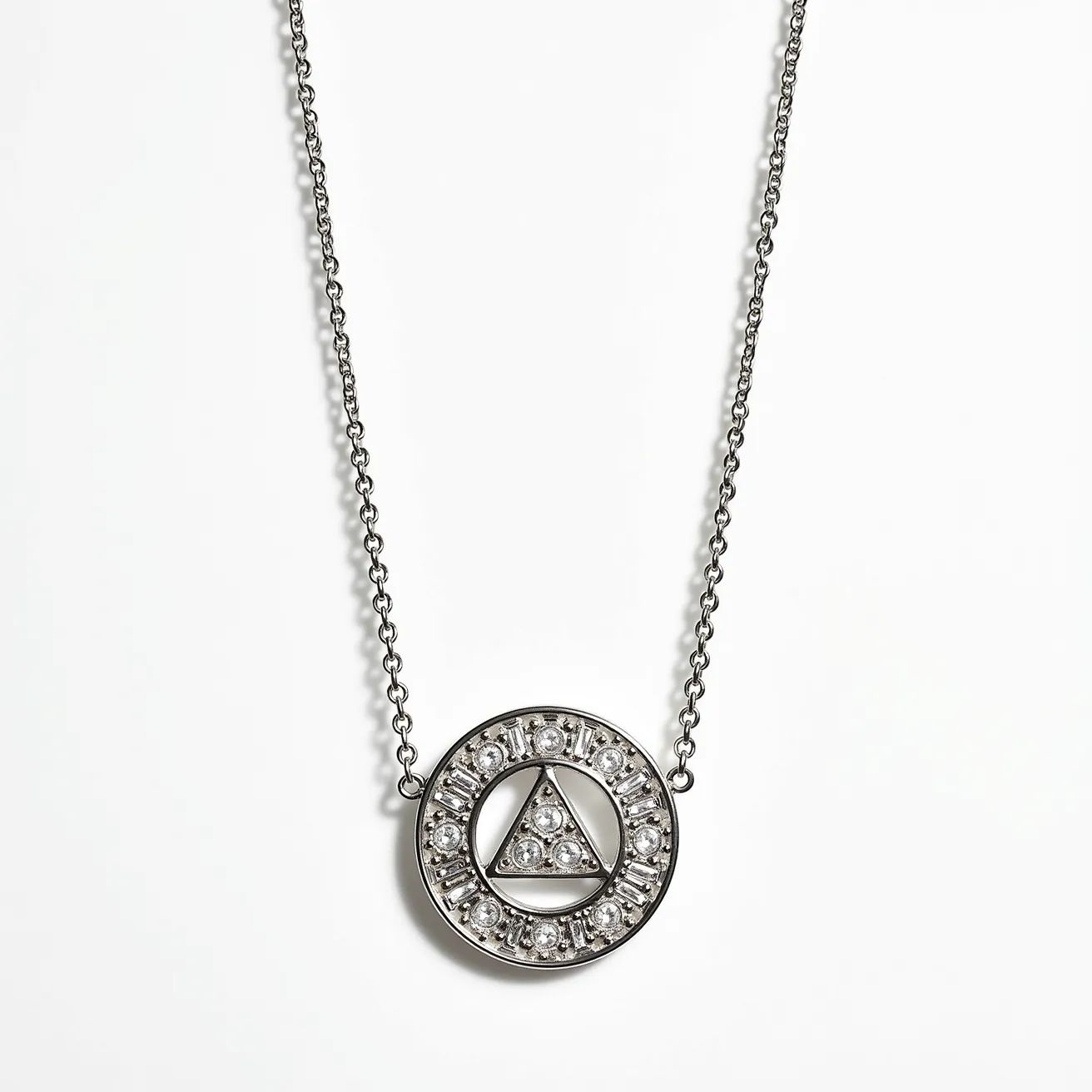 This platinum necklace features an intricately designed circular pendant adorned with sparkling gemstones. The pendant showcases a triangular arrangement of three finely cut gems at its center, which are set securely in prong settings. Surrounding this central motif is a polished circular frame embedded with a series of evenly spaced round brilliant-cut stones, enhancing the necklace’s overall elegance. Attached to a delicate chain, the necklace is likely secured with a discrete clasp, ensuring both security and aesthetic appeal. The combination of platinum and sparkling stones gives the piece a refined and luxurious appearance.