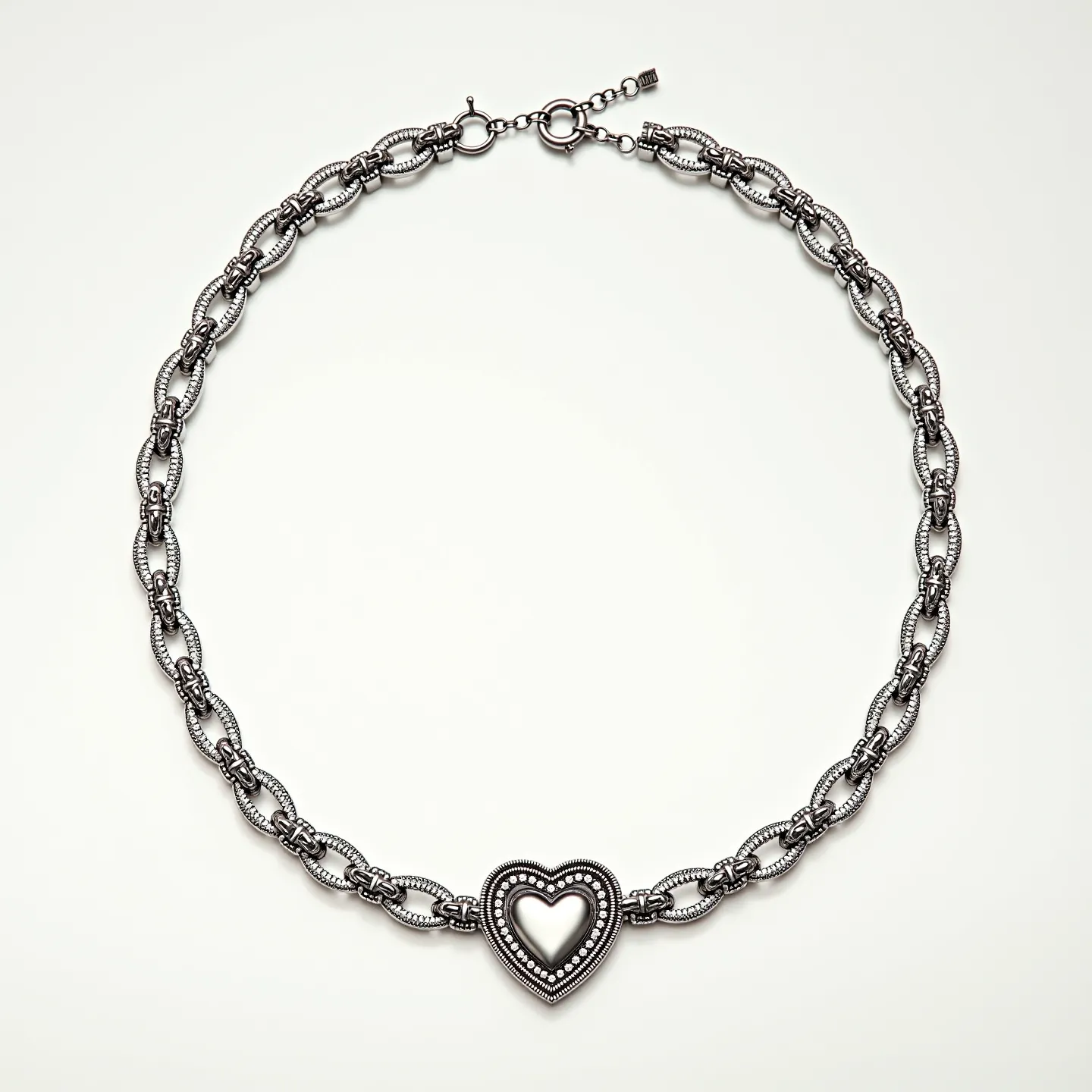 This promise necklace features a distinctive design with a series of oxidized silver links that form an intricate chain. The central focal point is a heart-shaped pendant, adorned with a detailed beaded edge that enhances its elegance. The necklace is secured with a lobster clasp, ensuring a secure fit. The overall craftsmanship reflects a combination of sophistication and sentiment, making it a meaningful accessory.