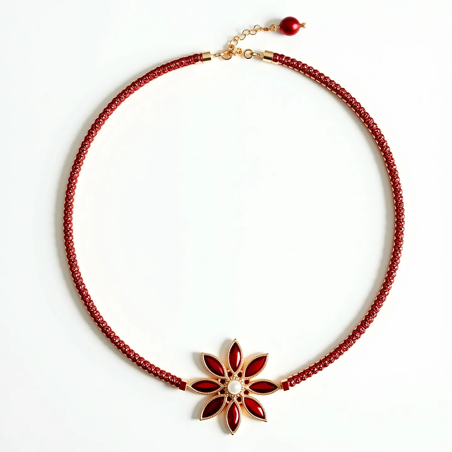 This red necklace features a finely crafted structure composed of small, uniform red beads threaded together to create a vibrant and cohesive strand. At the center, a striking floral pendant is adorned with marquise-cut, deep red stones set in a gold-toned frame, radiating outward in a symmetrical pattern. At the core of this floral design lies a single, round pearl-like stone that adds a touch of elegance. The necklace is secured with a simple lobster clasp and an adjustable chain that ends with a matching red bead, offering both functionality and an additional decorative element.