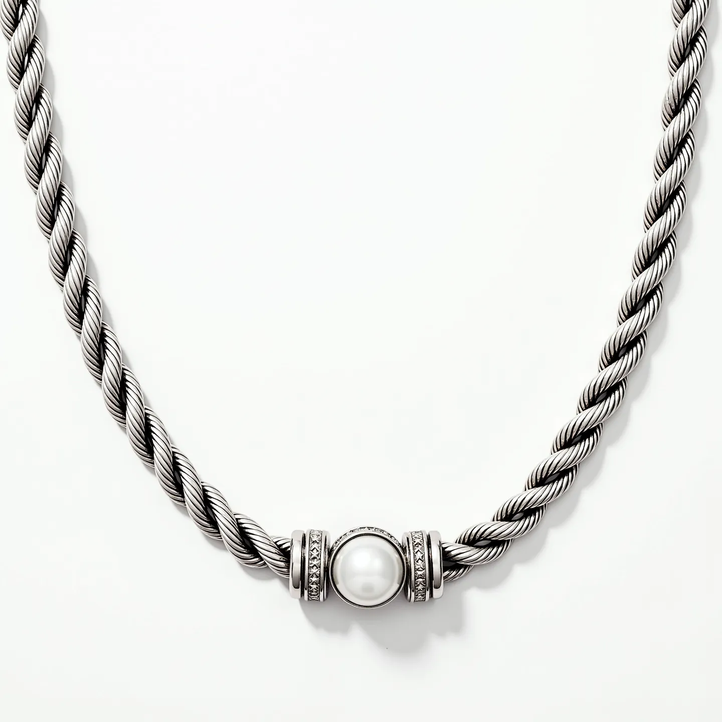 This rope chain features a twisted design typically crafted from polished metal, possibly silver or stainless steel, displaying a sophisticated and timeless aesthetic. At its center, it showcases a prominently set pearl, accentuated by a setting that includes rows of small pavé diamonds or diamond-like stones encircling the pearl. The central decoration provides a classic and elegant touch to the overall design. The chain likely has a secure and matching clasp, though it is not depicted here, ensuring both style and functionality.