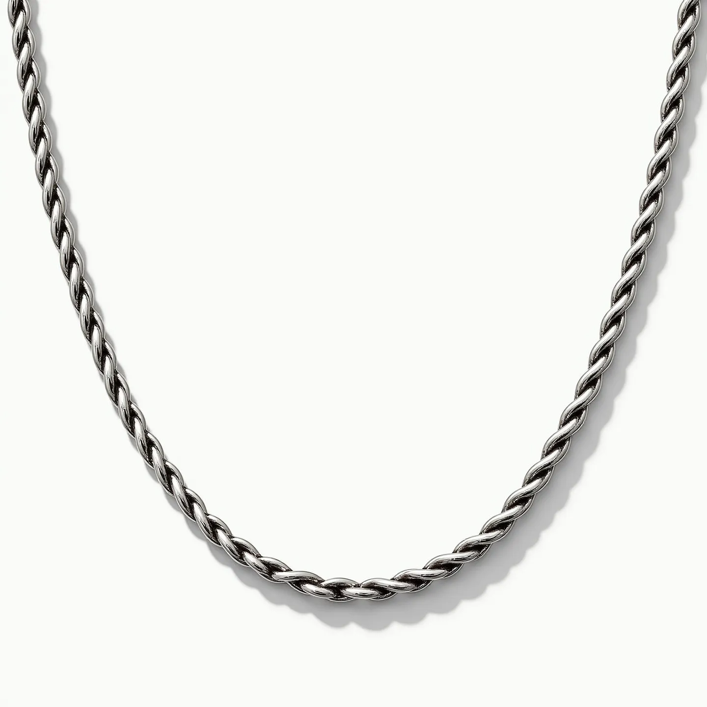 This rope chain features a classic twisted design typically found in such jewelry. It appears to be made of a polished metal, possibly silver or white gold, known for its reflective, bright finish. The chain does not showcase any gemstones, maintaining a sleek and uniform look throughout. At one end, it likely includes a standard clasp mechanism, such as a lobster claw or spring ring, providing secure attachment and ease of wear. The consistent spiral pattern adds both visual interest and strength to the overall structure of the chain.