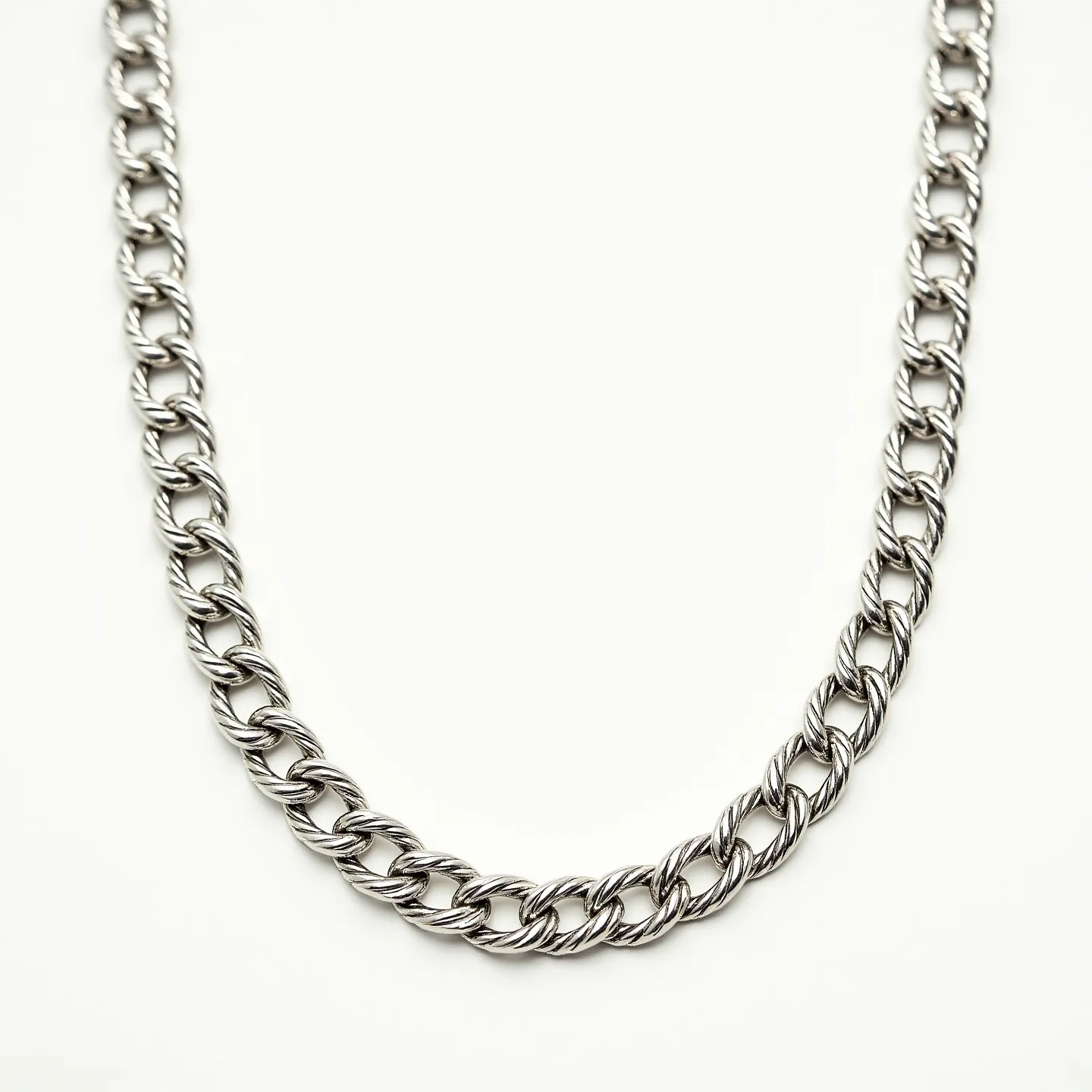 This rope chain features a classic twisted design crafted from a polished metal, likely silver or stainless steel given its reflective sheen and color. The links are tightly intertwined, creating a cohesive and sturdy appearance. There are no visible gems or stones set into the chain. The chain likely includes a standard clasp, typically a lobster claw or spring ring, to ensure secure wear. The craftsmanship reflects a timeless style suitable for both casual and formal occasions.