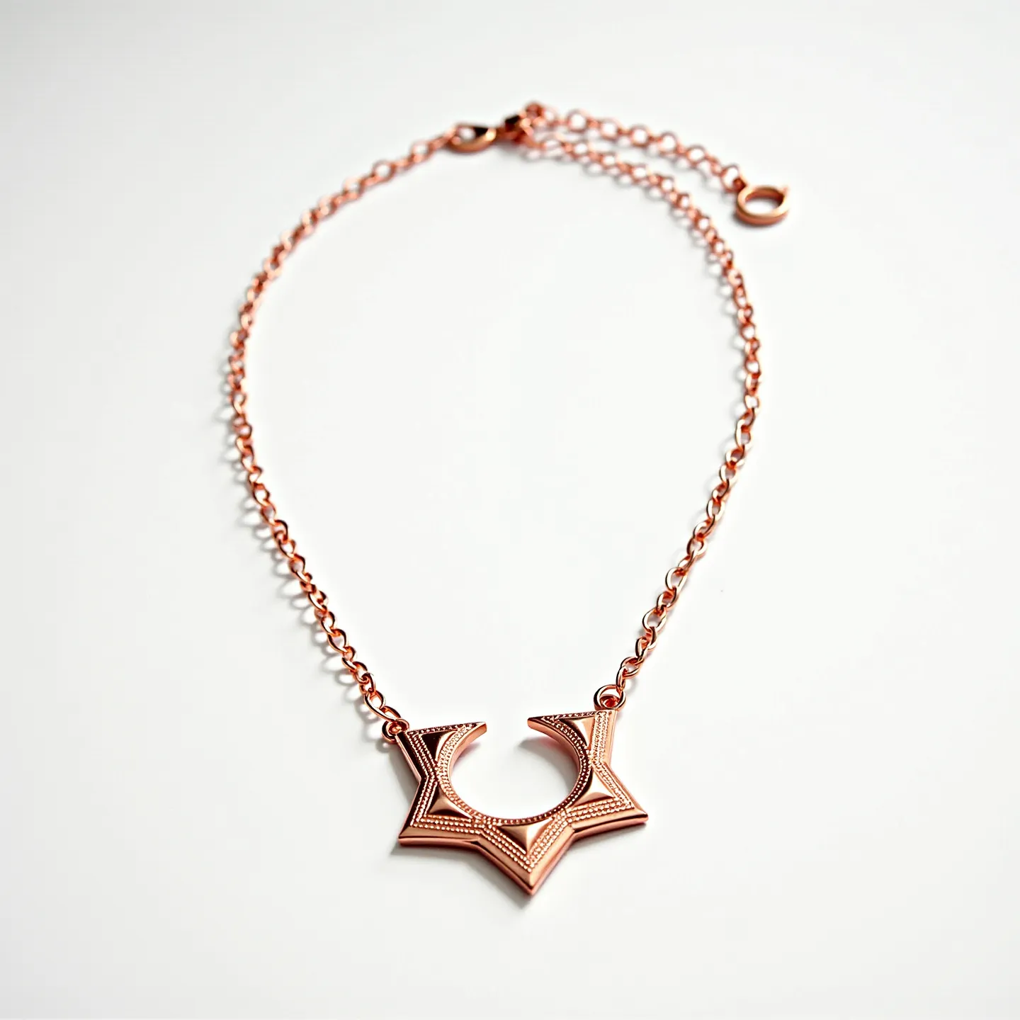 This rose gold necklace features a stylish, geometric pendant that showcases an intricate design. The necklace chain is crafted from rose gold links, providing a warm and elegant glow. The pendant does not contain any visible gemstones, focusing instead on the architectural design. The piece is secured with a lobster clasp, ensuring a reliable closure, and includes an extender chain adorned with a small circular charm for adjustable length.