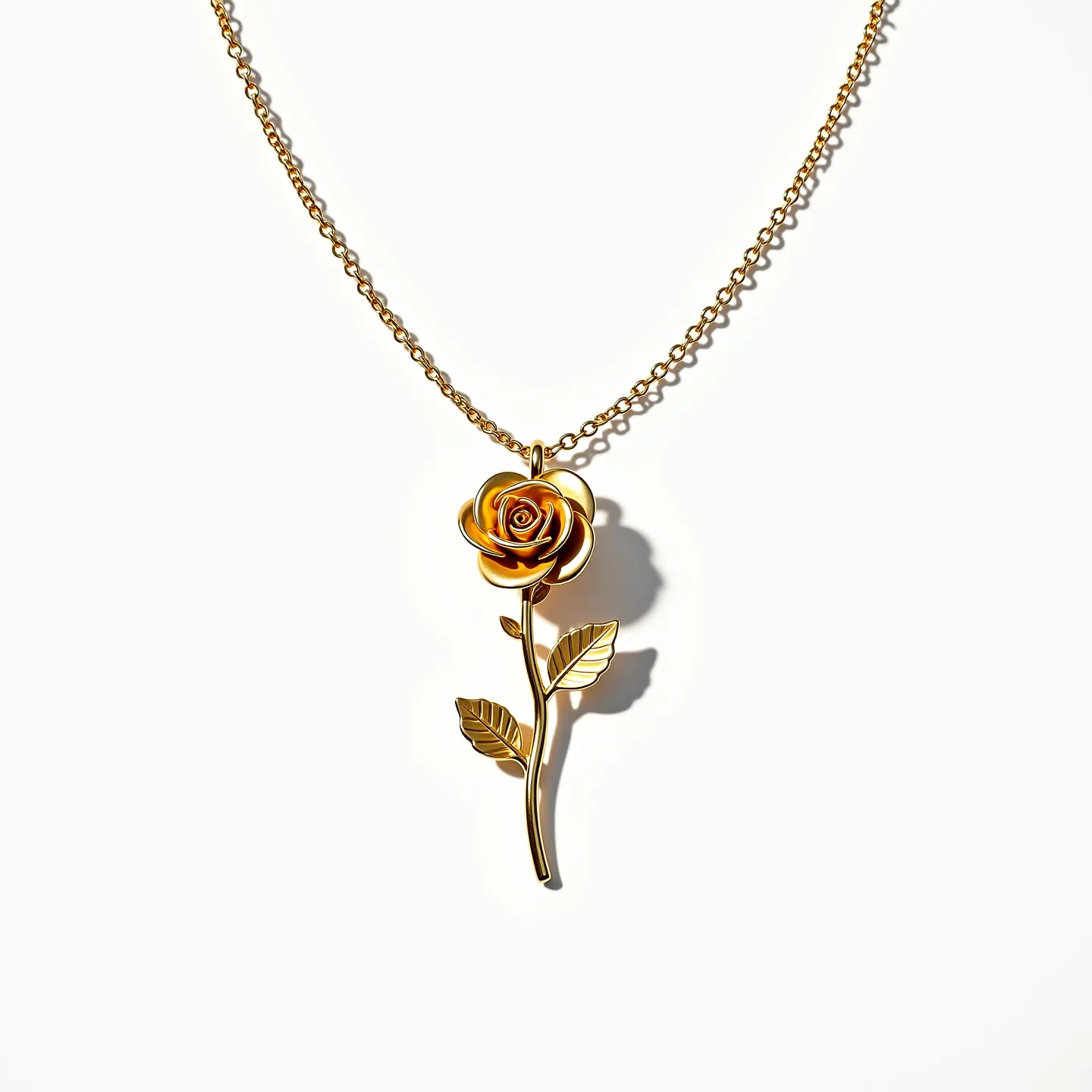 This rose necklace showcases an elegant design with a delicate gold chain that complements a beautifully crafted rose pendant. The pendant features intricate detailing of the petals and leaves, giving it a lifelike appearance. The rose is depicted in a lustrous gold finish, emphasizing its luxurious appeal. The pendant hangs from the chain through a loop situated at the top, ensuring it is securely attached. This piece's simplicity and craftsmanship make it a timeless accessory suitable for various occasions.