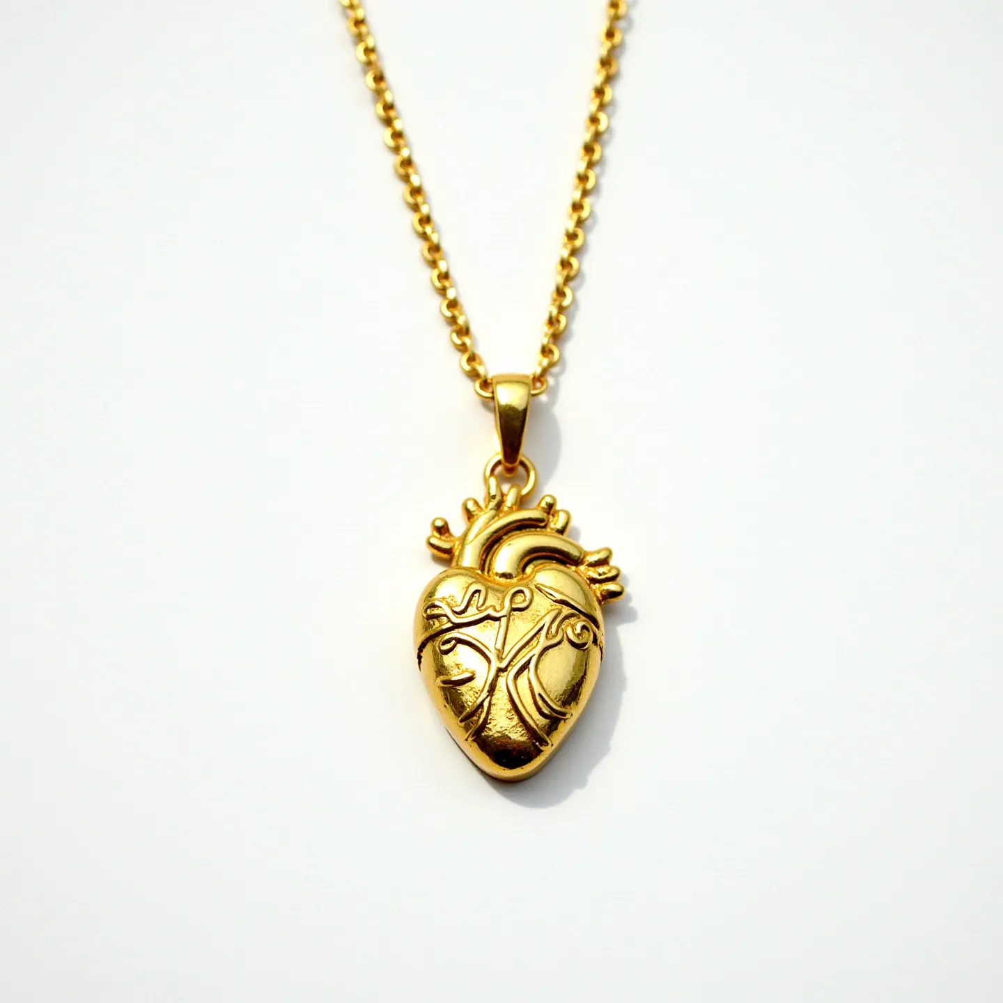 This sacred heart necklace features a pendant designed in the shape of a stylized anatomical heart, crafted from a gold-toned metal. The surface of the pendant is adorned with intricate engravings that add a textural detail. The necklace is completed with a chain that matches the pendant's color, suggesting it is made from the same or a complementary material. The pendant is connected to the chain via a smooth, rounded bail which seamlessly integrates the piece into a cohesive design.