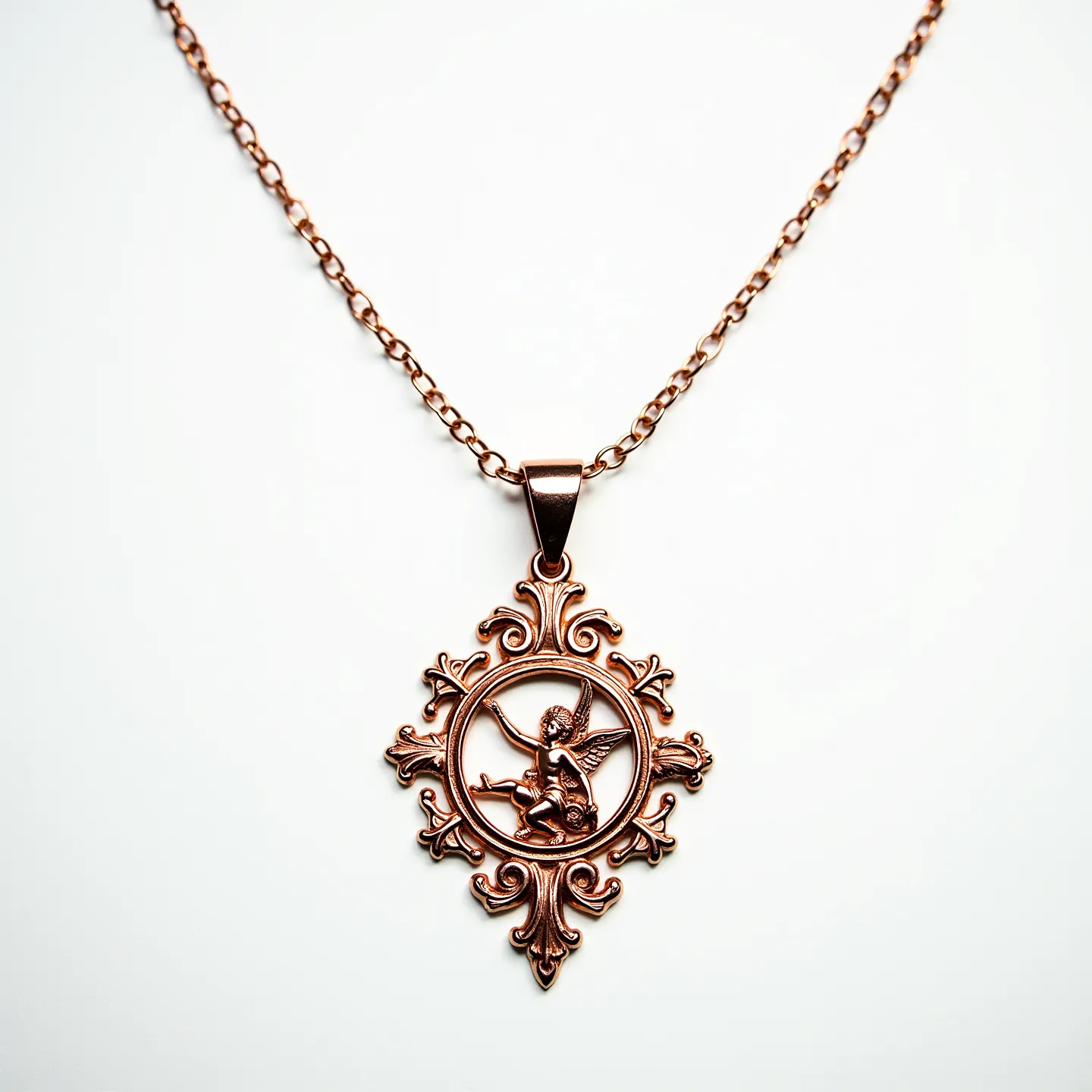 This Saint Michael necklace features a detailed pendant crafted in a warm, golden-toned metal, possibly bronze or gold-plated alloy. The pendant showcases an intricate design of Saint Michael, with a decorative border resembling elegant, symmetrical flourishes. The chain consists of interlinked round links, contributing to a classic and timeless aesthetic. The pendant is attached to the chain with a simple bail, allowing for smooth movement. The clasp of the necklace appears to be a standard lobster clasp, ensuring secure closure and easy wearability. The absence of any gemstones or additional embellishments emphasizes the detailed metalwork of the piece.