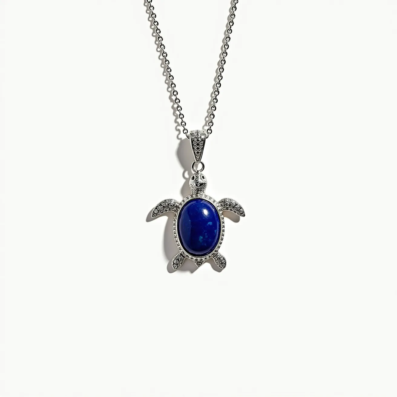 This sea turtle necklace features a striking design with a large, oval-shaped blue stone set in the center, likely fashioned from lapis lazuli. The stone is smooth, indicating a cabochon cut, and is secured in a bezel setting that highlights the turtle's body. Surrounding the central stone, the turtle's limbs and head are encrusted with small, sparkling clear gems, possibly diamonds or cubic zirconia, set in a pavé arrangement. The pendant is attached to a delicate chain via a detailed bail, which is also adorned with small clear stones, adding to the necklace's overall elegance. The chain appears to be composed of fine metal links, secured by a standard clasp mechanism, ensuring both security and ease of wear.