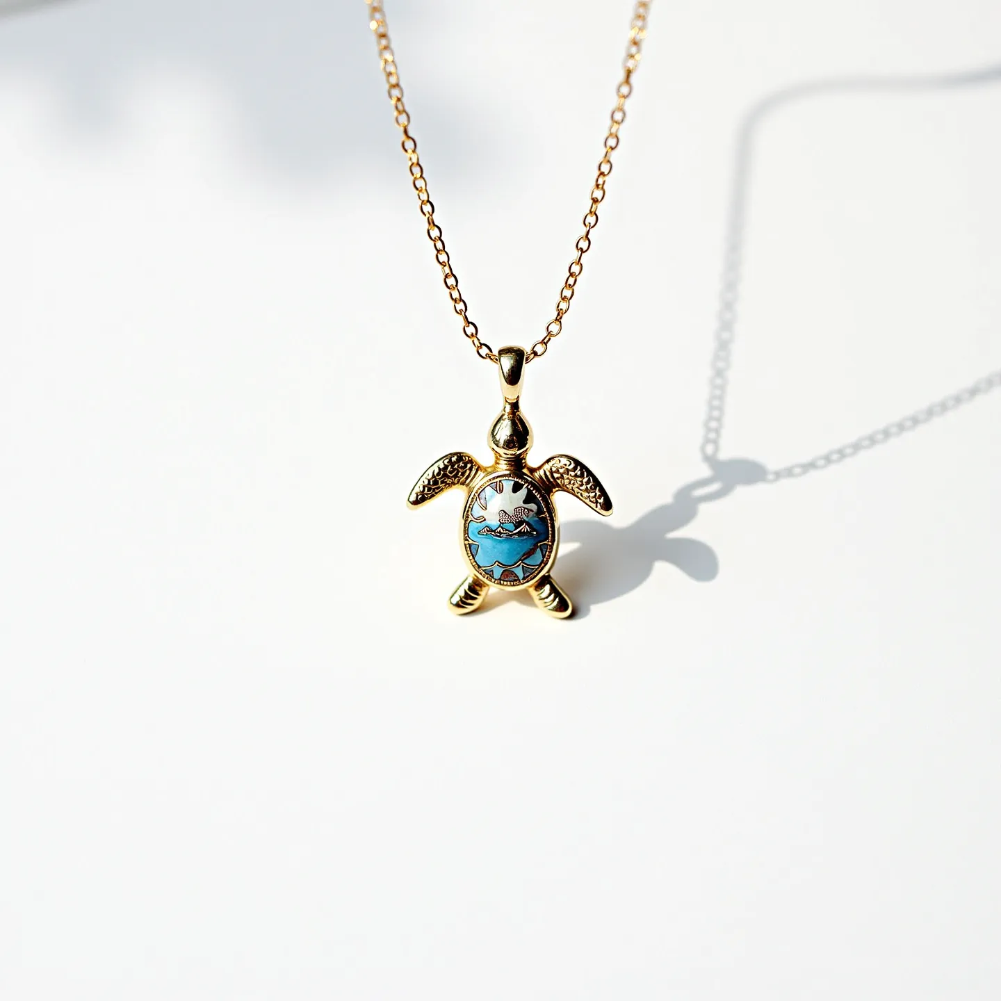 This sea turtle necklace showcases a charming pendant crafted in a gold-toned metal, depicting the shape of a turtle. The turtle's shell is adorned with a vibrant blue inlay that appears to resemble an ocean wave design, adding a touch of color and visual interest. The pendant is suspended from a delicate chain, also in a matching gold tone, which complements the overall elegance of the piece. The necklace features a simple, unobtrusive clasp that ensures secure wearing while maintaining the design's aesthetic appeal. This piece embodies a harmonious blend of artistry and nature-inspired motifs.