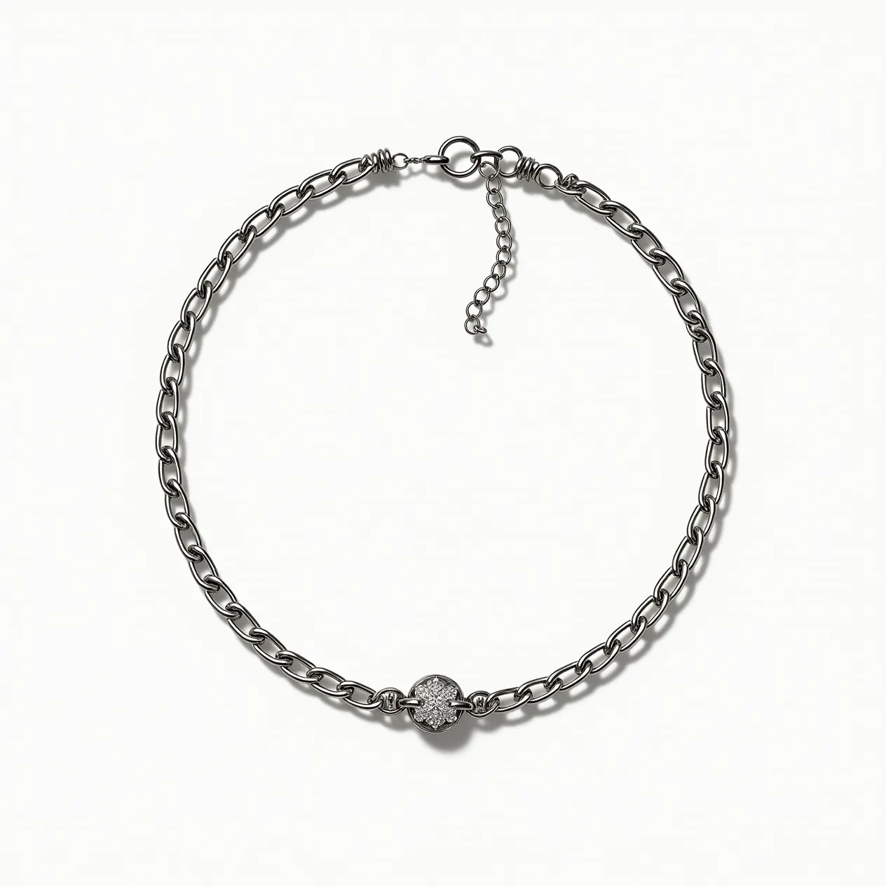 This silver choker necklace features a series of polished, interlinked chain loops with a prominent accent at the center. The central element is a round charm, adorned with small, sparkling gems likely set in a pavé style, offering a dazzling effect. The choker is equipped with an adjustable clasp mechanism, featuring a lobster clasp along with an extension chain that allows for size adjustments. The silver finish gives the necklace a sleek, modern appearance, making it a versatile accessory.