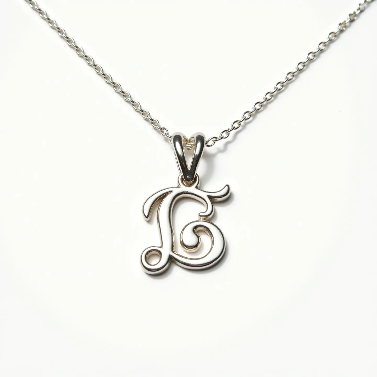 This silver initial necklace features a delicately crafted letter "E" as its pendant, showcasing a sleek and polished finish typical of sterling silver. The elegant cursive design of the letter adds a touch of personalization and sophistication to the piece. The pendant is attached to the chain via a simple yet sturdy bail, which seamlessly integrates with the necklace. The chain is composed of small, evenly spaced links that provide both strength and flexibility. The necklace likely uses a standard clasp, ensuring ease of wear and security for the pendant.