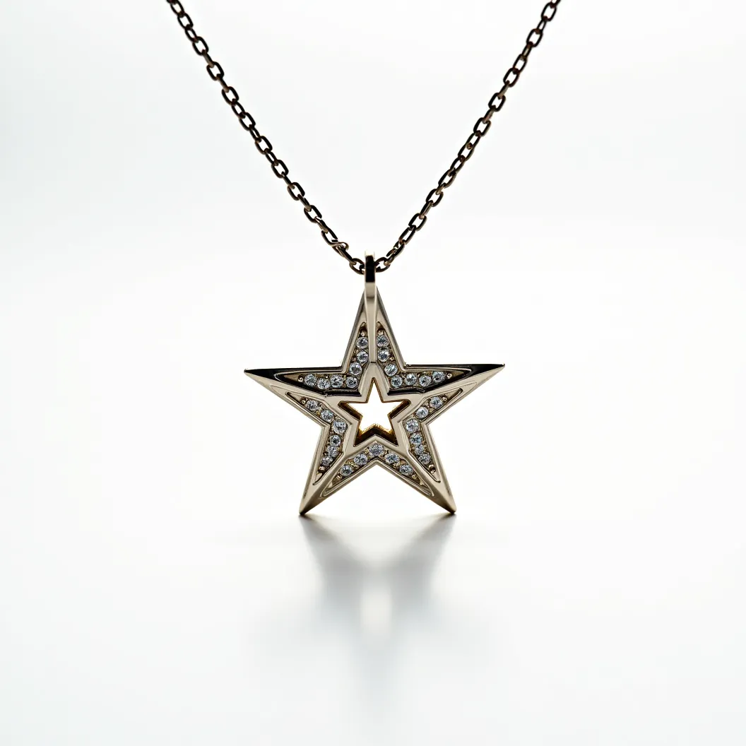 This star necklace features a pendant crafted from a gold-toned metal, shaped into a dual-layered star design. The outer star is set with small, round-cut clear gemstones, likely diamonds or cubic zirconia, which are set into a channel that outlines the star's edges. The gems add a sparkling effect, enhancing the elegance of the piece. The inner star is a smaller, gold-toned silhouette that provides a striking contrast against the gem-embellished outer star. The necklace is attached to a delicate chain with evenly spaced links and includes a small, secure clasp for fastening.