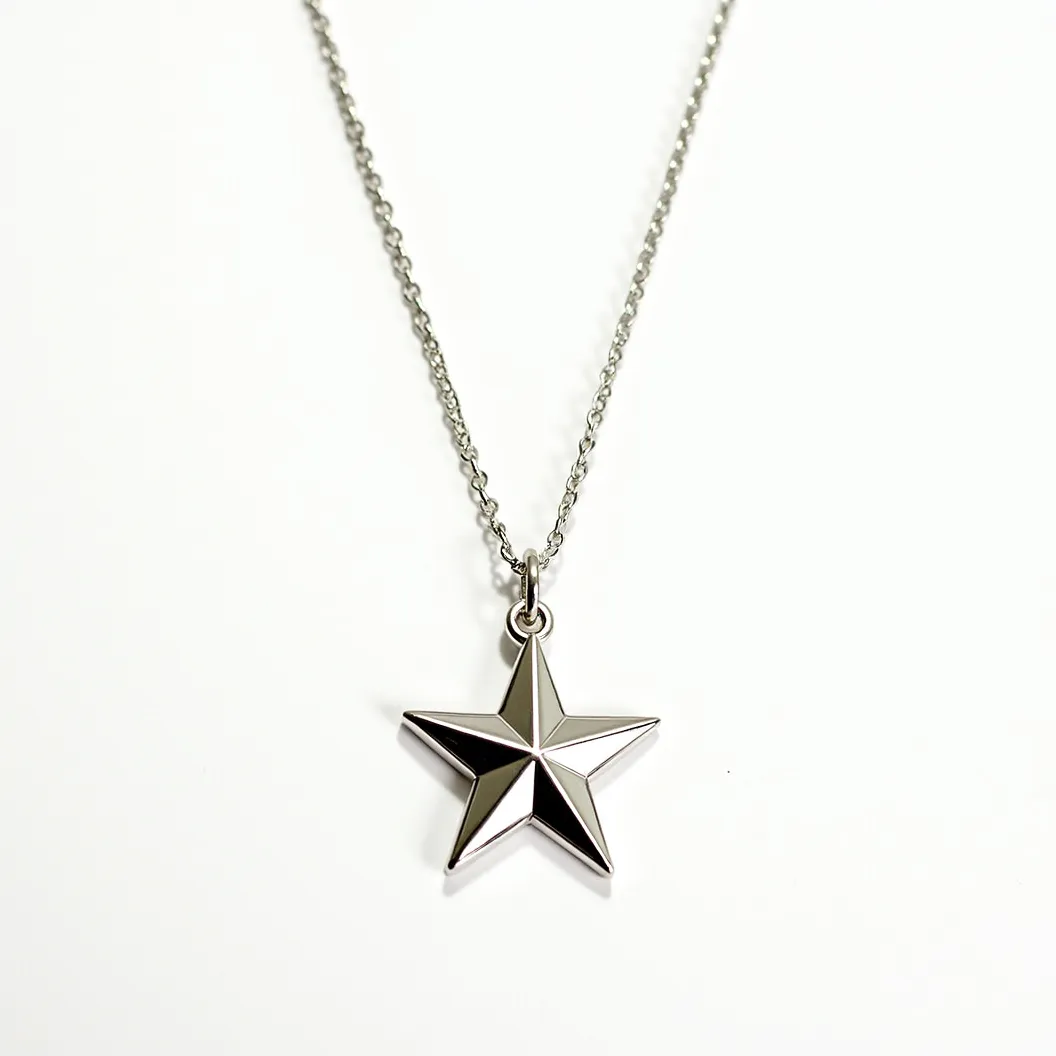 This star necklace features a sleek and polished star-shaped pendant made of a shiny metal, likely stainless steel or a similar alloy. The star has a minimalist, geometric design with clean, angular lines, giving it a modern and understated elegance. It is attached to a delicate chain that complements the pendant's material, and the chain appears to be secured with a typical jewelry clasp, possibly a lobster clasp, ensuring both functionality and style. The pendant is connected to the chain by a simple loop or bail, allowing it to hang freely and align neatly, adding to its refined and elegant appearance.