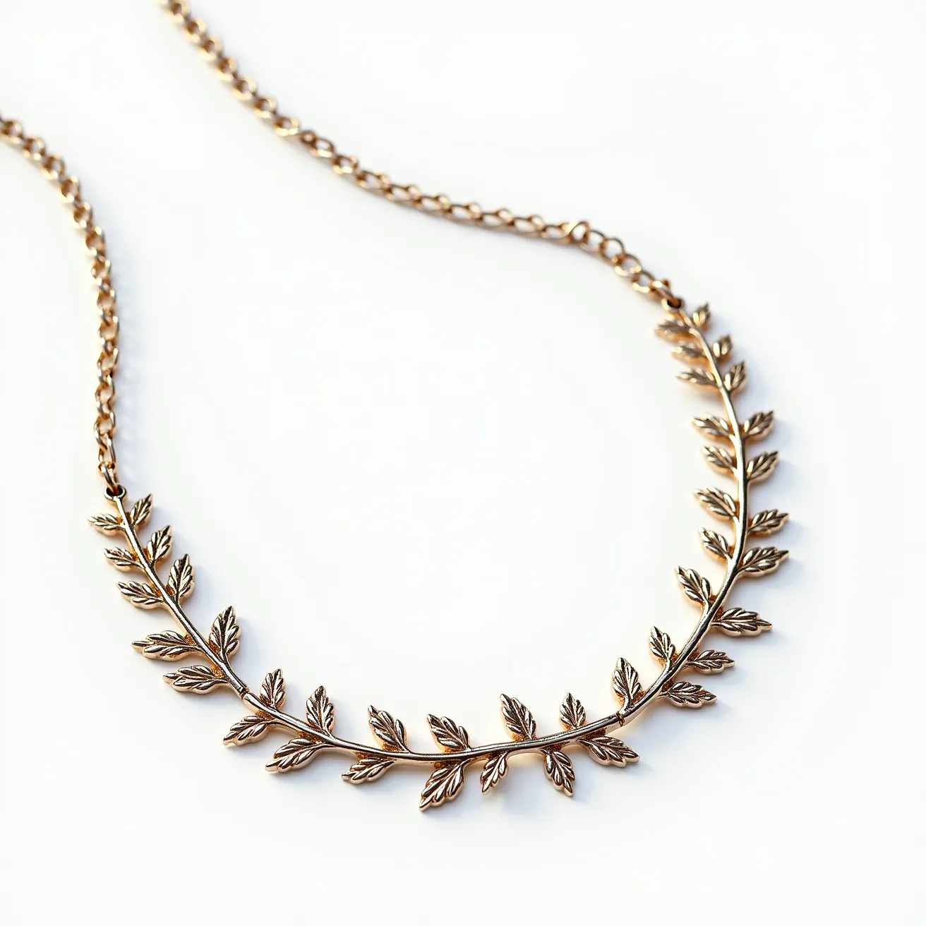 This sterling silver necklace features a delicate leaf motif, with each leaf intricately crafted to form a series of alternating designs linked along the chain. The leaves are detailed, emphasizing their veins and contours, creating a naturalistic and elegant appearance. The chain is composed of oval links that provide both durability and a graceful drape. The necklace is fastened with a classic lobster clasp, ensuring secure wear while retaining a polished finish. There are no gemstones set within the design, allowing the craftsmanship of the silver leaves to stand out as the necklace's primary feature.