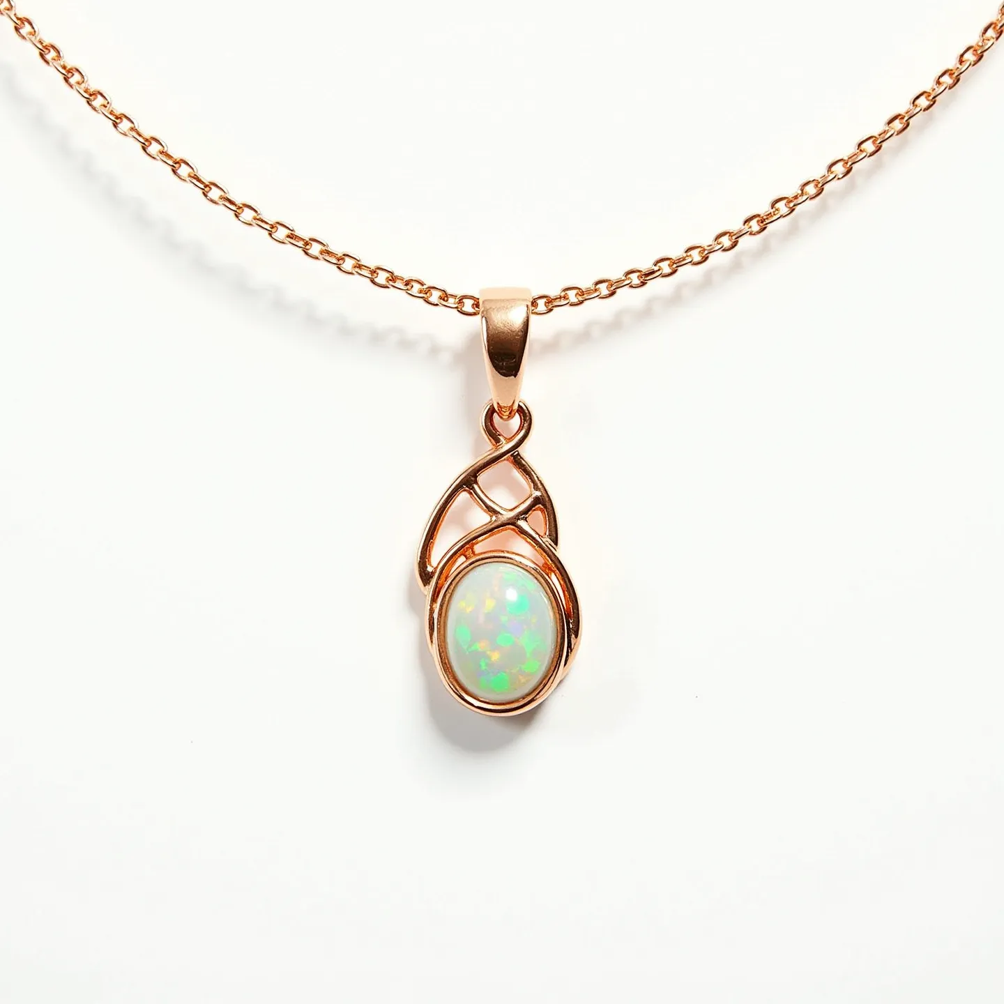 This stone necklace features a captivating opal set in a rose gold pendant. The opal, showcasing a play of colors typical of its kind, is cut in an oval cabochon style, allowing for the gem's iridescent qualities to be fully displayed. The opal is secured by an elegant and intricate swirl pattern setting, which enhances its natural beauty and is crafted to complement the stone's rounded shape. The chain is a delicate rose gold link design that harmonizes with the pendant, offering a seamless and elegant appearance. The necklace is completed with a simple and secure clasp that ensures ease of wear while maintaining the piece’s refined aesthetic.