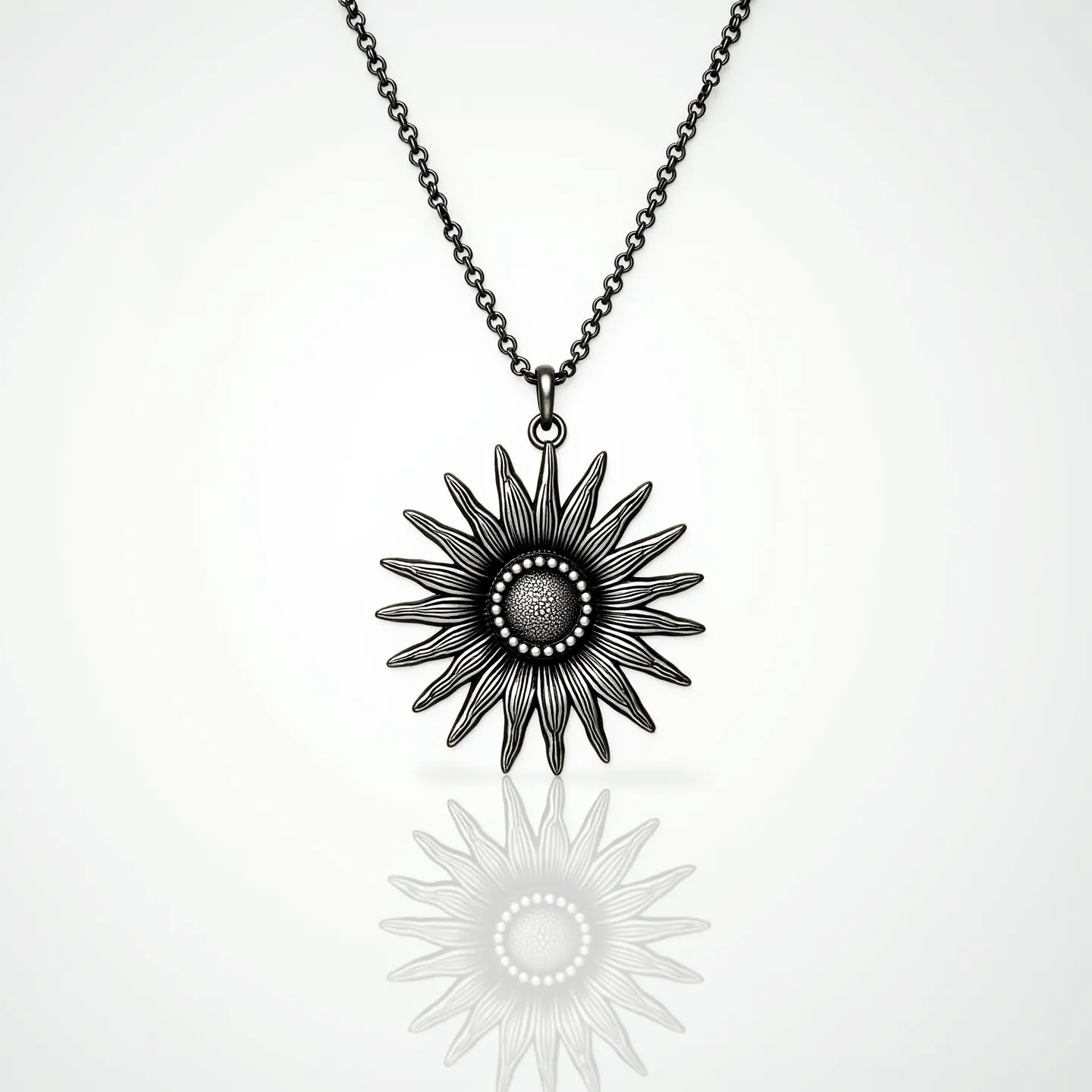 This sunflower necklace features a detailed metal sunflower pendant with intricately designed petals and a textured center. Exhibiting a dark metallic finish, the pendant hangs from a chain with an oxidized appearance, adding a vintage or antique aesthetic. The pendant is attached to the chain through a simple loop, allowing it to dangle freely. This piece is likely crafted from materials like silver or stainless steel, without any visible gemstones or intricate settings. The chain appears to be an adjustable length with a classic lobster clasp, ensuring ease of wear and security.