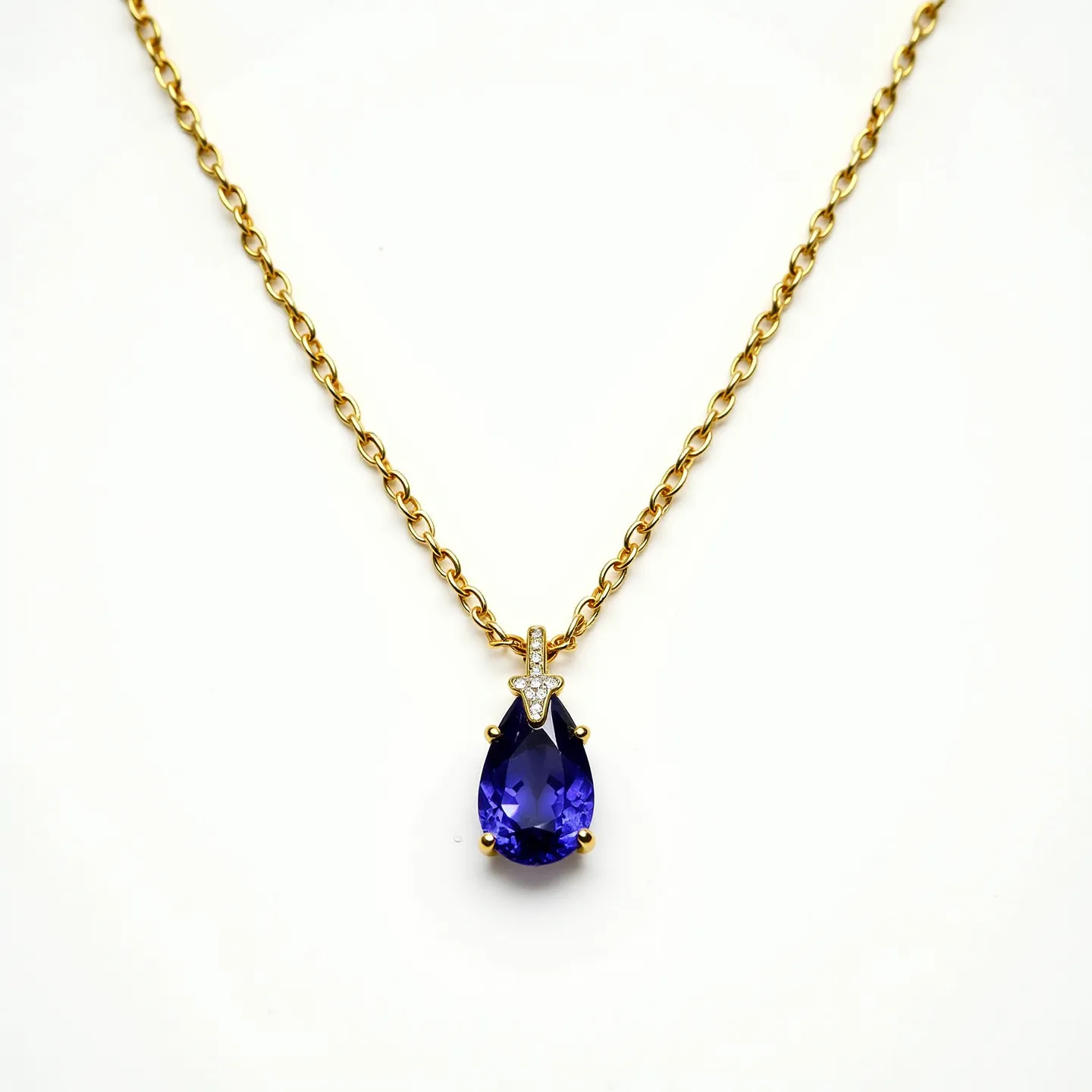 This tanzanite necklace features a teardrop-shaped tanzanite gemstone that exhibits a deep blue-violet hue, set in a delicate prong setting that highlights its vibrant color. Above the tanzanite, a small round-cut diamond adds a sparkling accent, secured in a complementary setting. The pendant is suspended from a gold chain, which showcases a classic cable pattern, offering both elegance and durability. A discreet and secure clasp ensures the necklace is fastened comfortably, rounding out its sophisticated design.