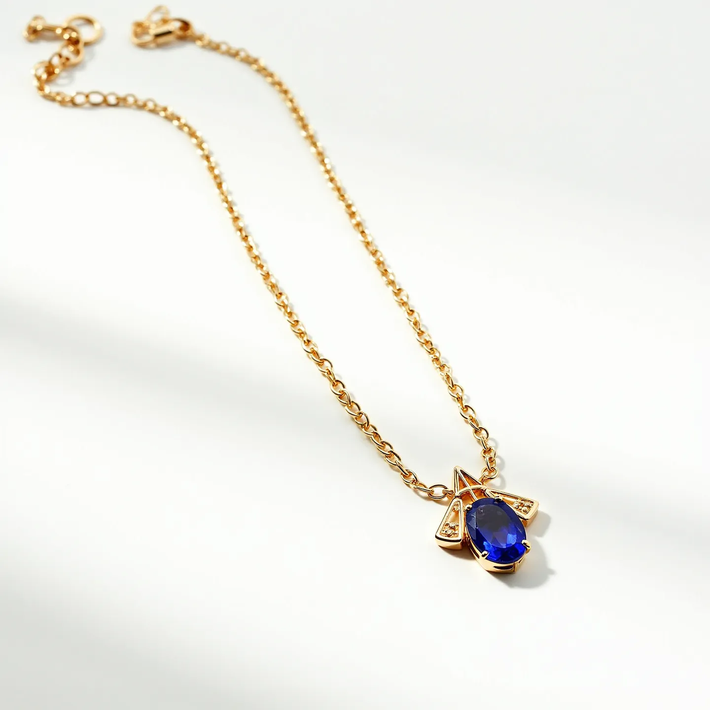 This tanzanite necklace features a striking blue oval tanzanite gemstone set in a gold pendant, which is further accented by small, clear stones, likely diamonds, nestled in geometric designs surrounding the centerpiece. The chain is composed of a finely crafted gold link arrangement, adding to the elegance and continuity of the piece. The necklace is equipped with a lobster claw clasp, ensuring secure closure and ease of wear. The combination of the vibrant tanzanite, the gleaming gold, and the sparkling accent stones creates a luxurious aesthetic.