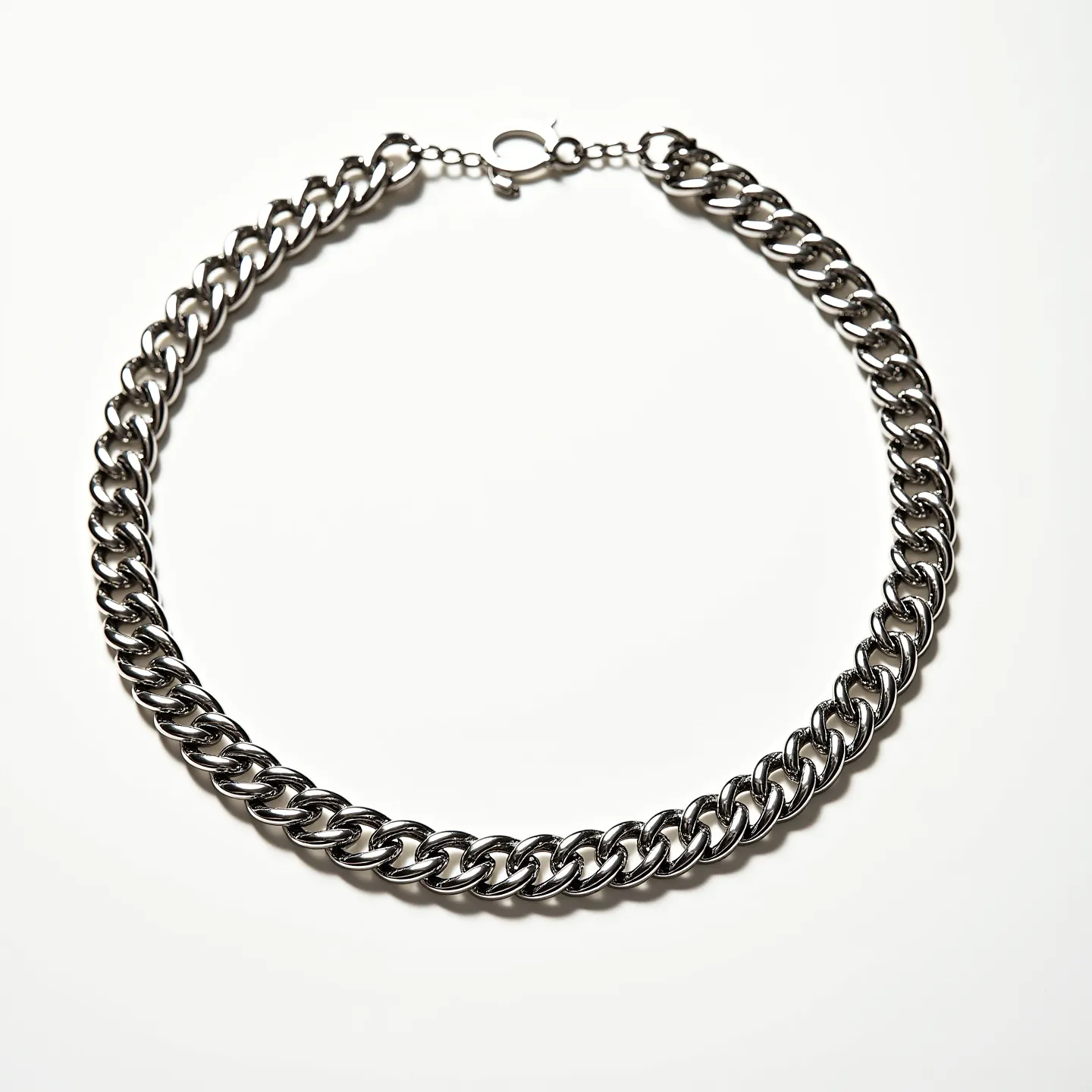 This thick chain necklace features a sturdy design formed by interlocking links with a polished, metallic finish, likely made from stainless steel or silver. The links are uniformly sized, giving the necklace a bold and substantial appearance. It is equipped with a lobster claw clasp, ensuring secure and easy wearing. The necklace design is simple yet elegant, making it suitable for a variety of fashion styles without the inclusion of any gemstones or additional embellishments.