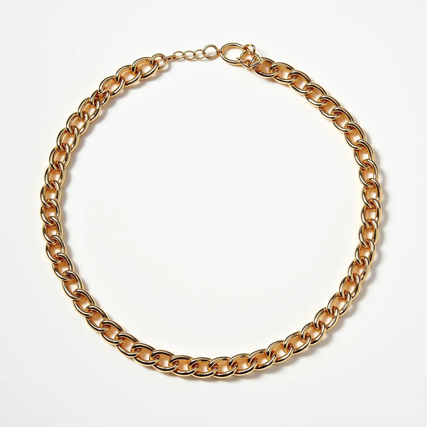 This thick chain necklace features sturdy, interlocking links made of a polished gold-toned metal. It has a classic oval shape, which contributes to a timeless and sophisticated aesthetic. The necklace is secured with a lobster clasp, offering both security and ease of use. The overall design is simple yet elegant, relying on the sheen of the material and the boldness of the chain links for its visual appeal. There are no additional embellishments such as gems or stones, allowing the focus to remain on the classic beauty of the chain's craftsmanship.