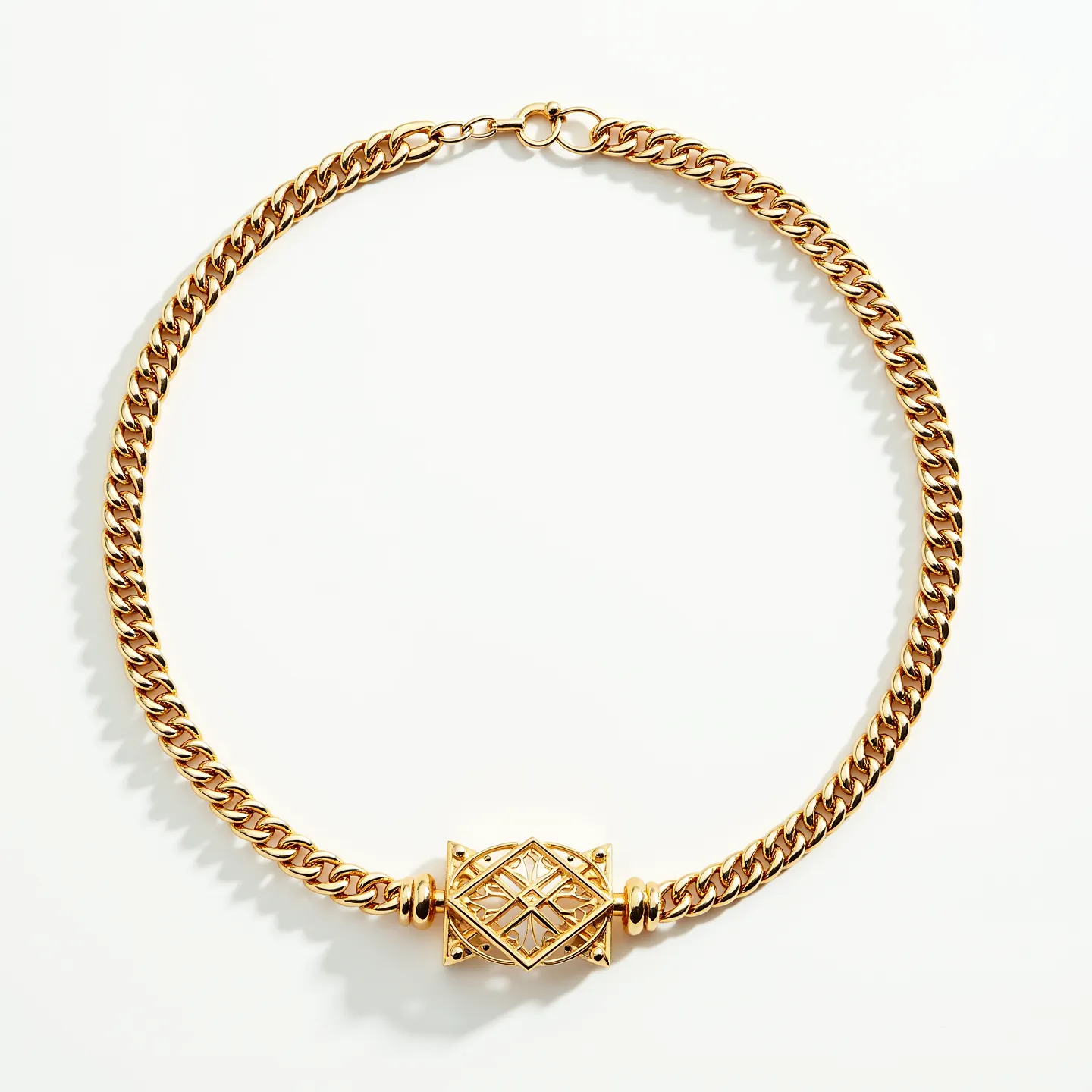 This thick chain necklace is crafted from a lustrous gold-toned metal, featuring a series of interlocking links that form a bold, substantial design. At the center, there is an ornate decorative element with an intricate geometric pattern, possibly containing a subtle gemstone or glass inlay that enhances its luxurious appearance. The central piece is framed by smaller gold-toned accents, adding to its visual intrigue. The necklace is secured with a classic spring ring clasp, ensuring both functionality and style for the wearer.