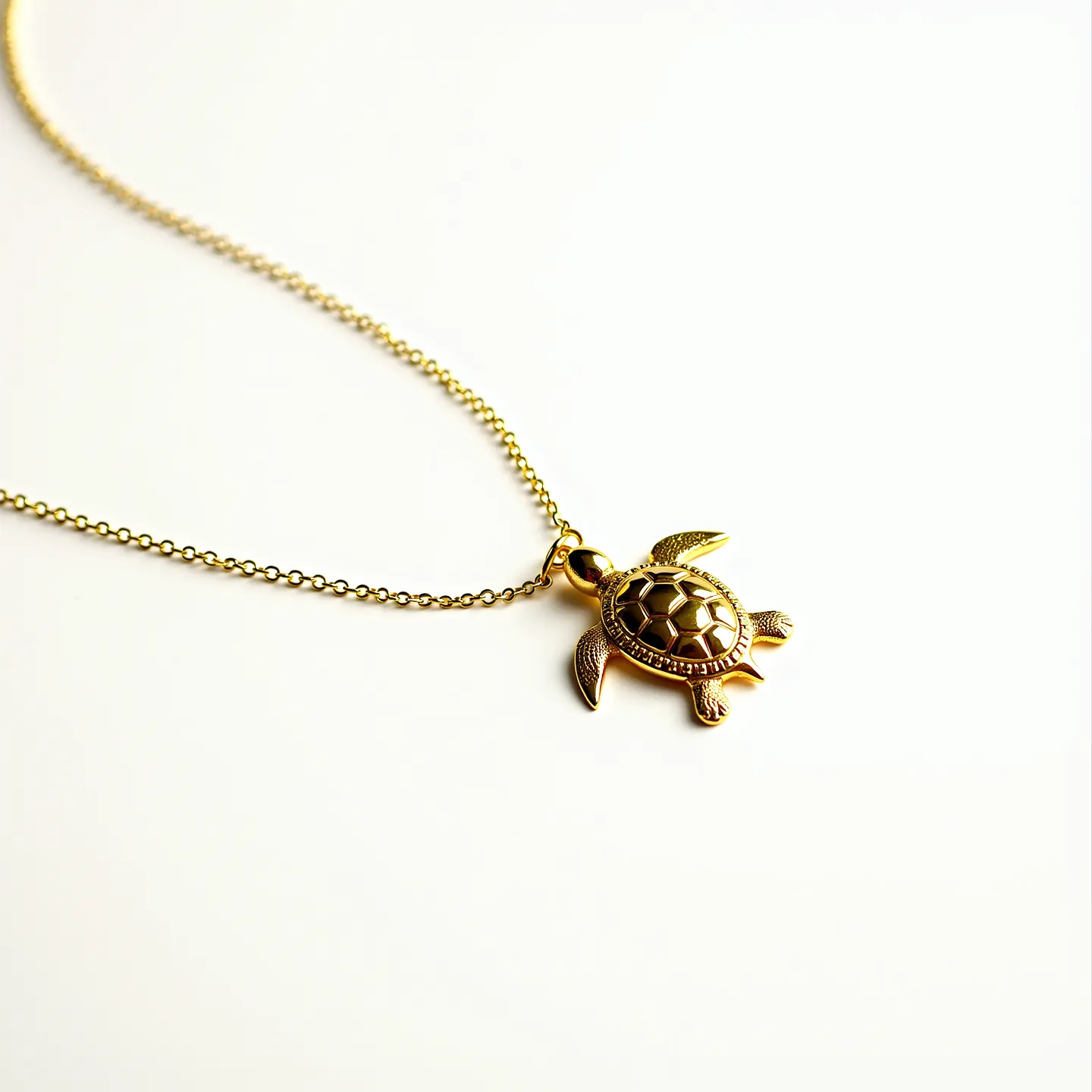 This turtle necklace features a gold-toned turtle pendant, intricately designed to highlight the details of the turtle's shell. The pendant hangs from a delicate, fine-link chain that complements its elegant appearance. The turtle's shell is adorned with a hexagonal pattern, enhancing its textured look. The chain is likely secured with a standard lobster clasp, offering a secure and adjustable fit. The overall aesthetic is both chic and charming, suitable for casual or formal attire.